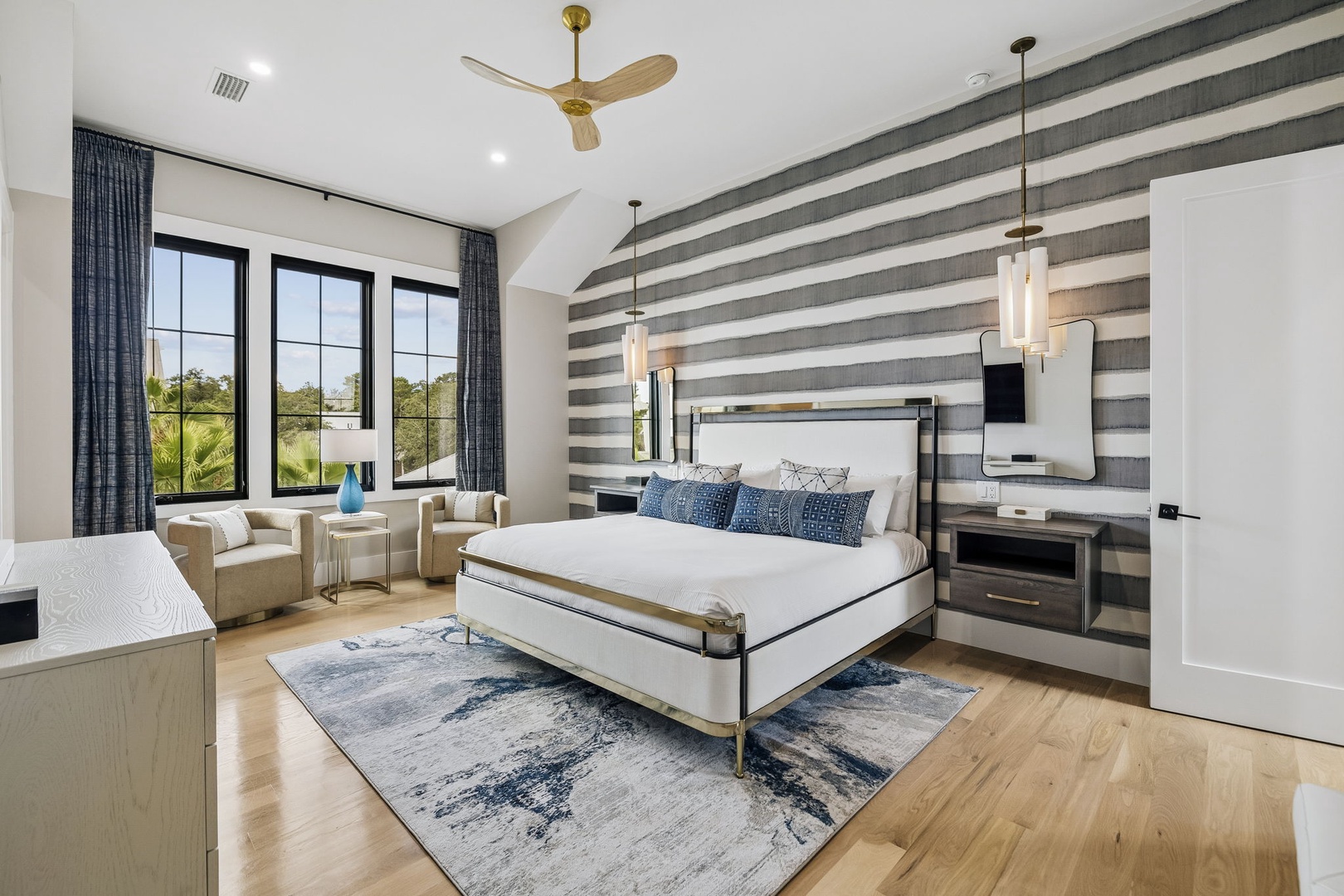 Wake up to natural light streaming through large windows in your beautifully appointed bedroom. Sink into premium bedding and enjoy a private seating area perfect for morning coffee or unwinding after exploring the area.