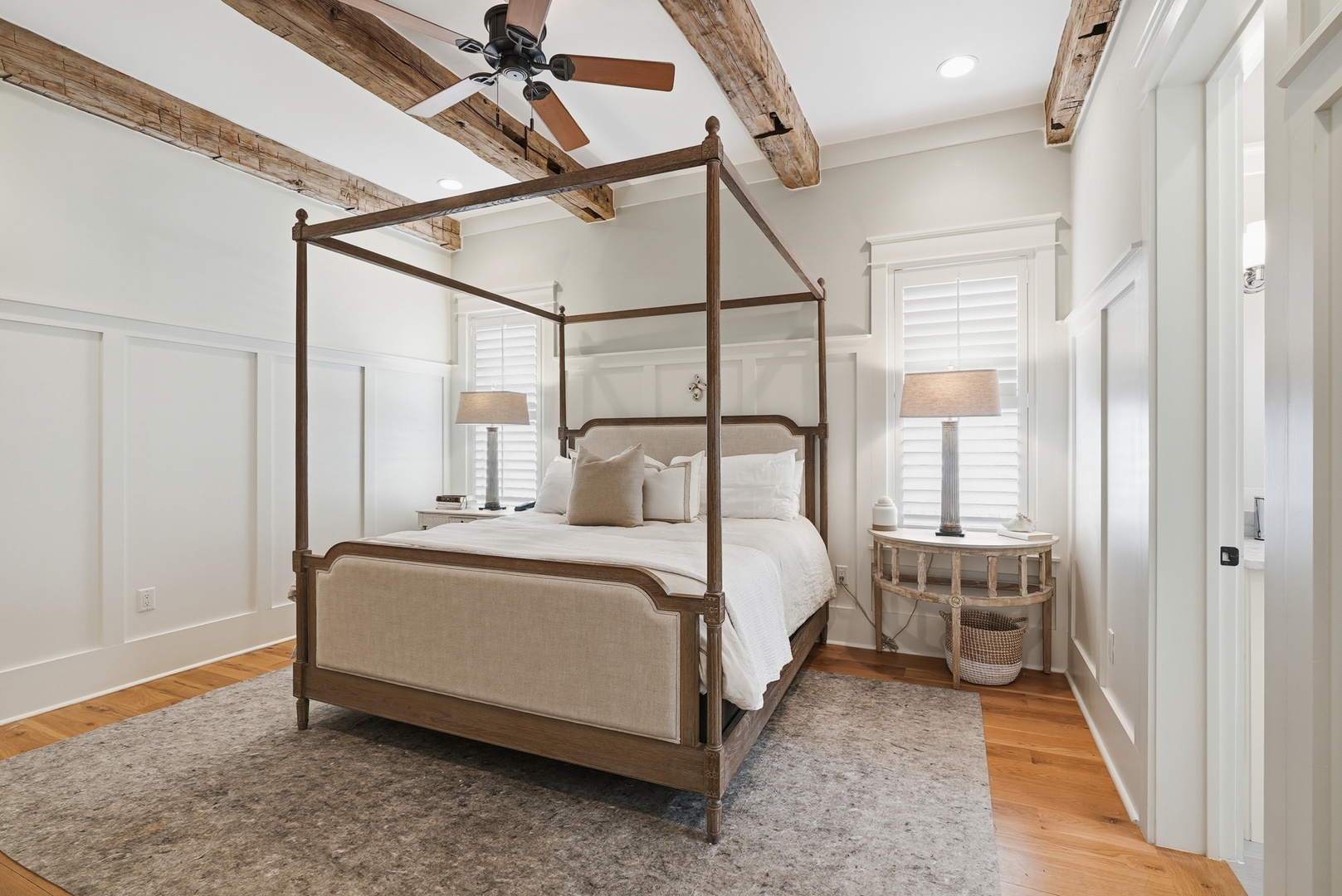 Sink into plush linens beneath rustic wood beams, where your elegant canopy bed and soft textures create the peaceful retreat you deserve.