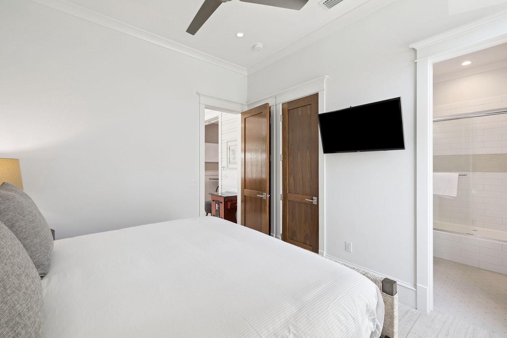 Sink into crisp white linens and catch up on your favorite shows from the comfort of your private bedroom retreat.