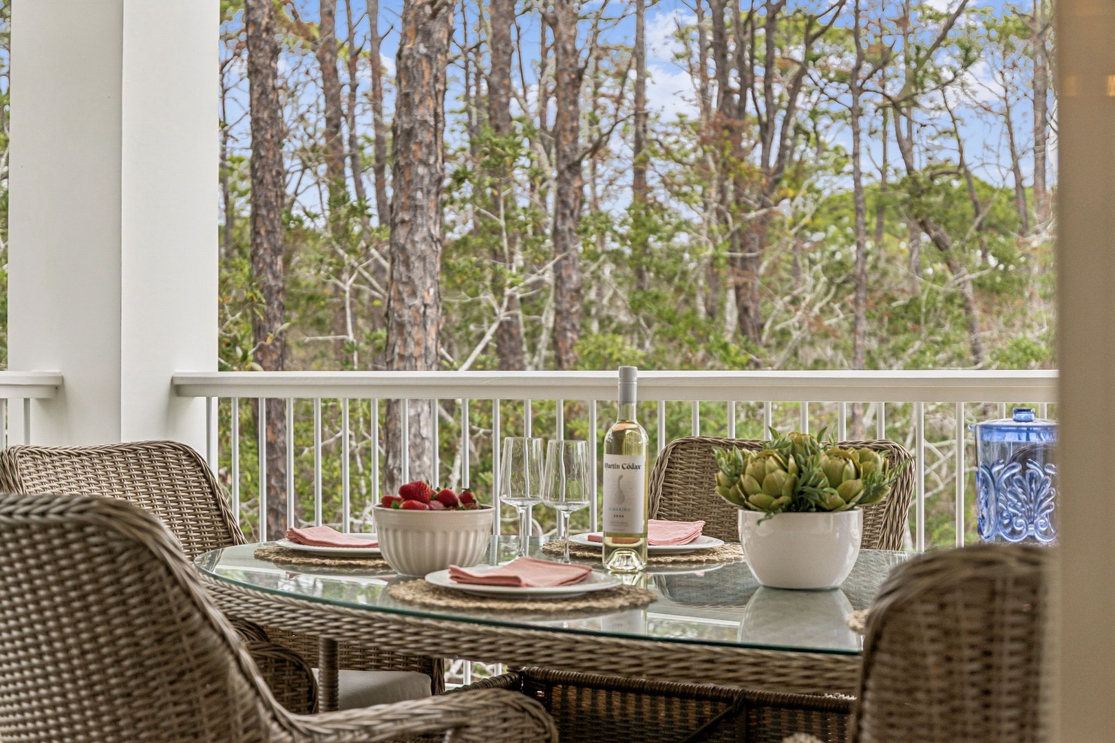 Savor your morning coffee or evening wine at this beautifully set dining table, where peaceful forest views create the perfect backdrop for memorable meals.