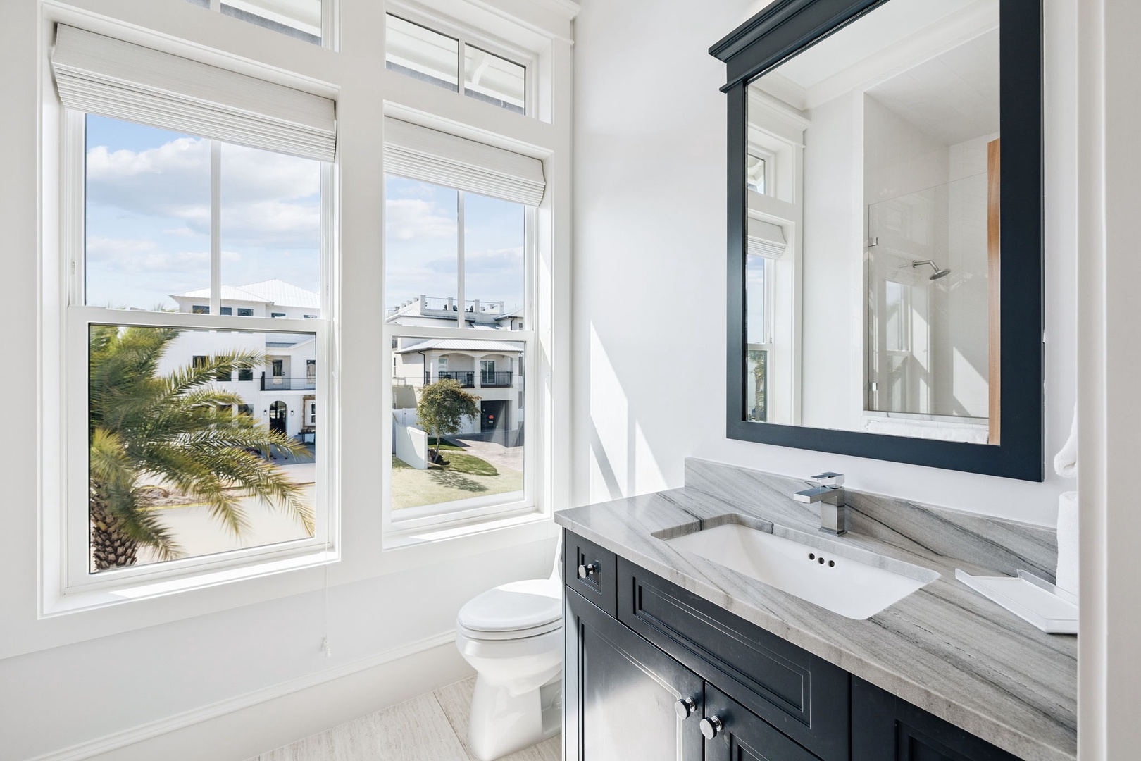 Your elegant bathroom features marble counters and tropical garden views to start each morning refreshed.