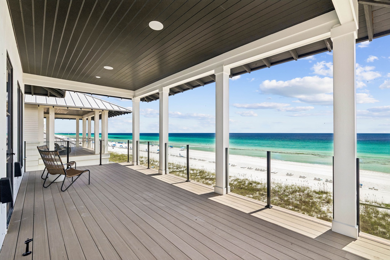 Step onto your private covered porch and drink in an unobstructed view of pristine white sand and shimmering turquoise water stretching to the horizon—perfect for morning coffee or sunset cocktails.