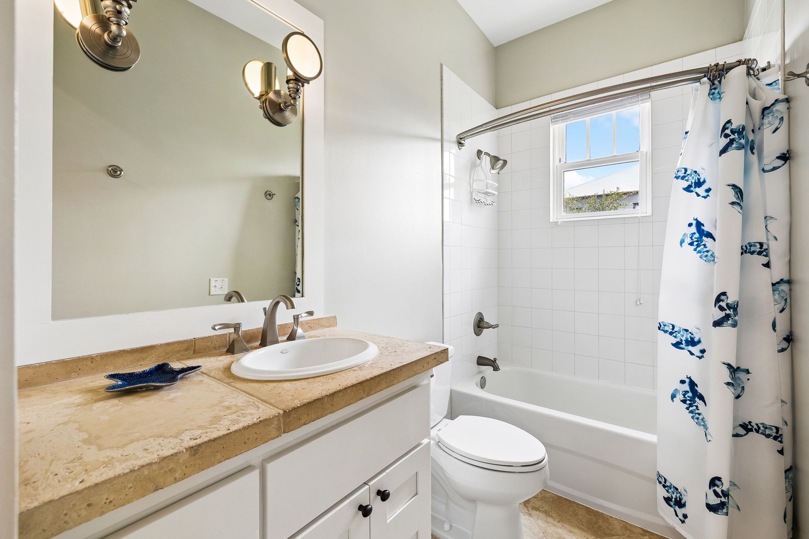 Refresh in your spotless bathroom with coastal accents and natural light streaming through the window. The soft tones and clean lines create a serene retreat.