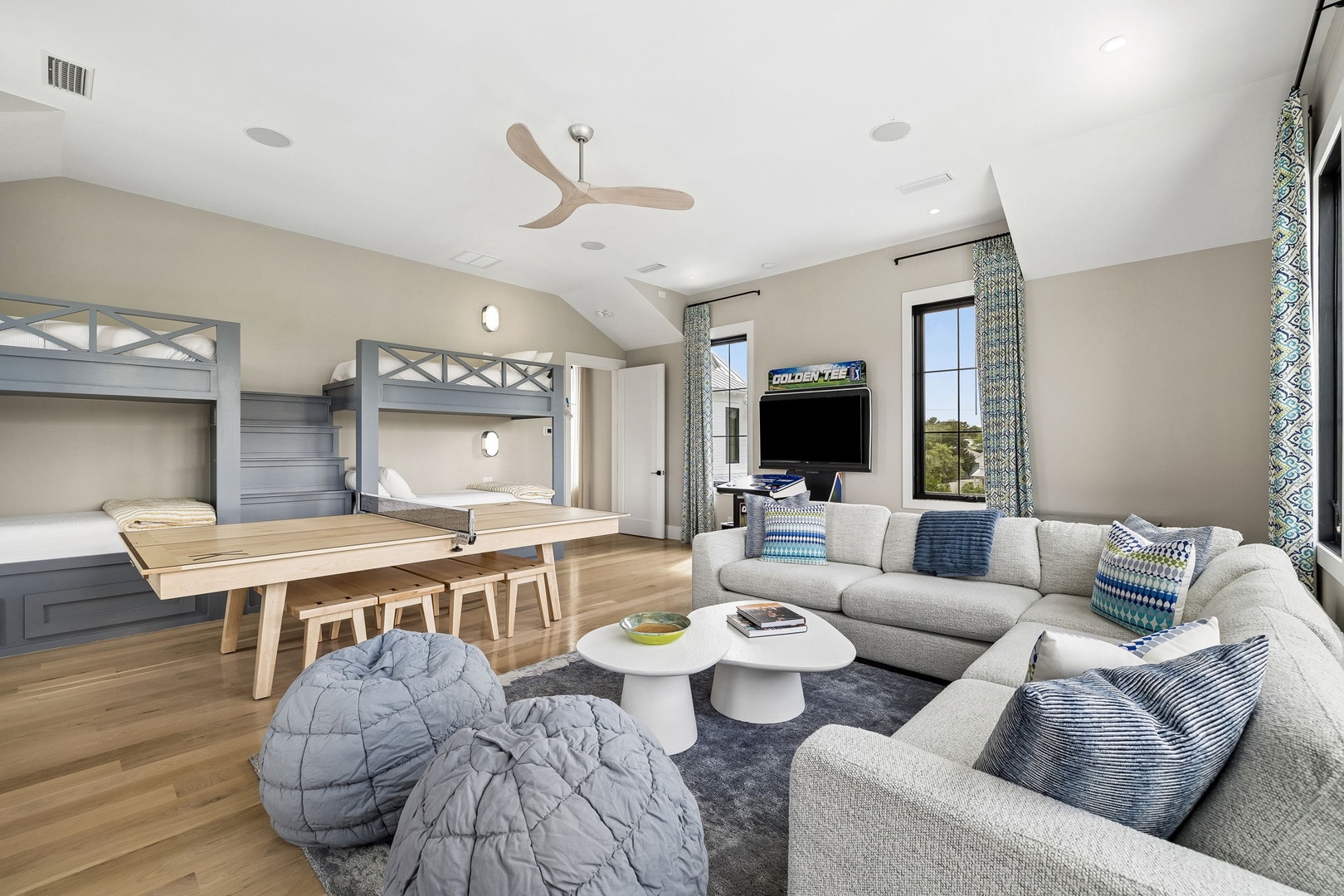 Your spacious retreat blends comfort and fun with custom bunk beds, plush seating, a dining table, and entertainment—all bathed in natural light from expansive windows.