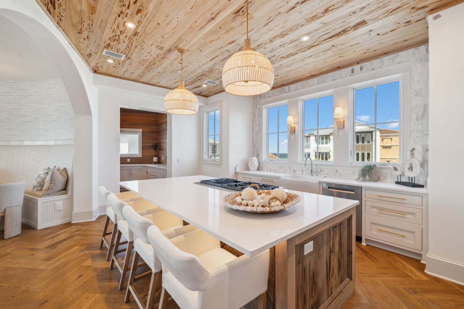 A stunning kitchen where you'll love preparing meals beneath a unique wood ceiling, with a spacious island perfect for gathering with family and friends over home-cooked favorites.