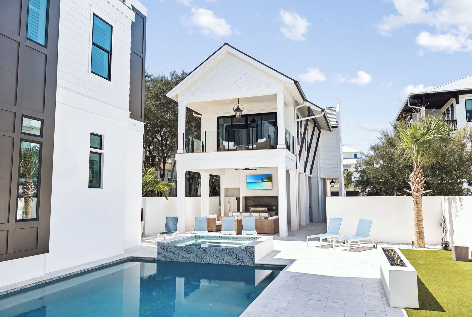 Resort-style retreat with modern sunbeds, raised spa, and covered outdoor area—ideal for relaxation and gatherings under the Florida sky.