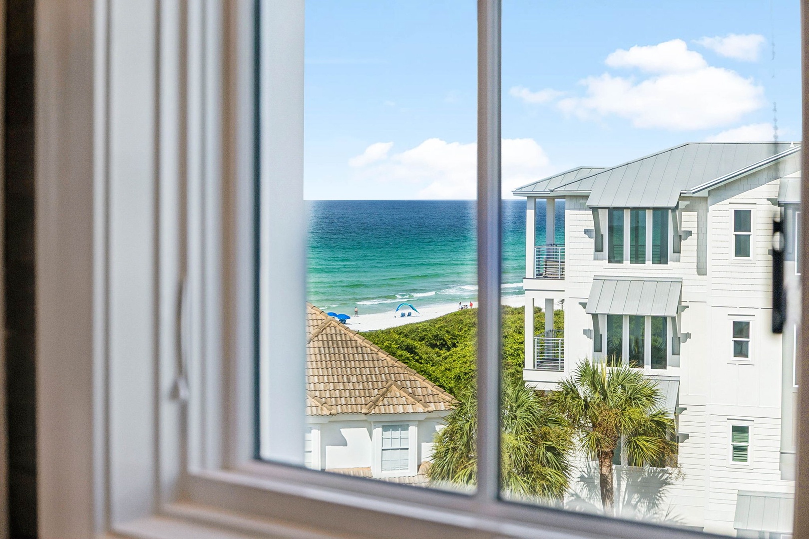 This coastal community offers proximity to pristine shoreline and beachfront charm, with neighboring homes sharing views of the turquoise Gulf waters.