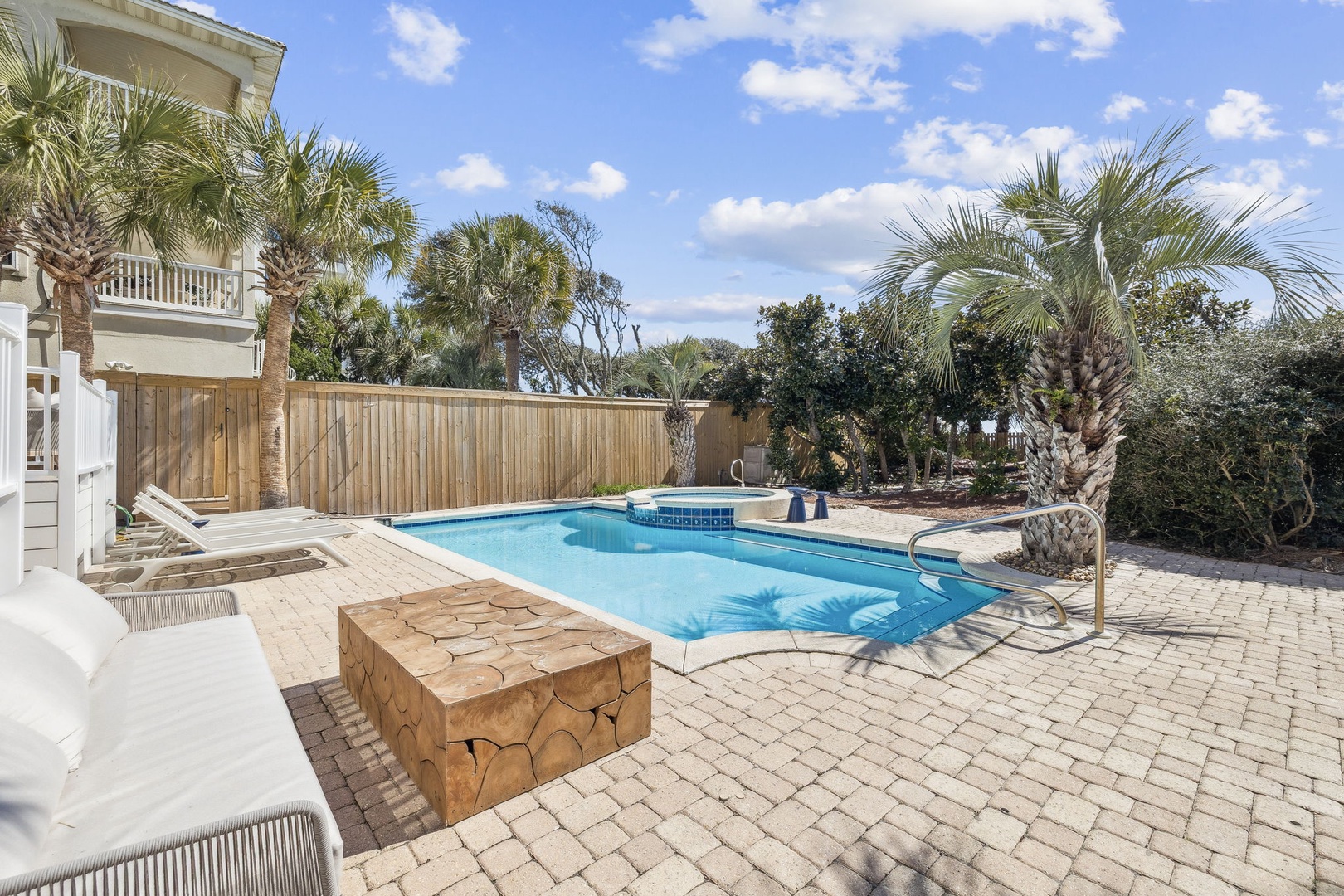 Dive into your private pool oasis surrounded by tropical palms and spacious lounging areas for ultimate relaxation.