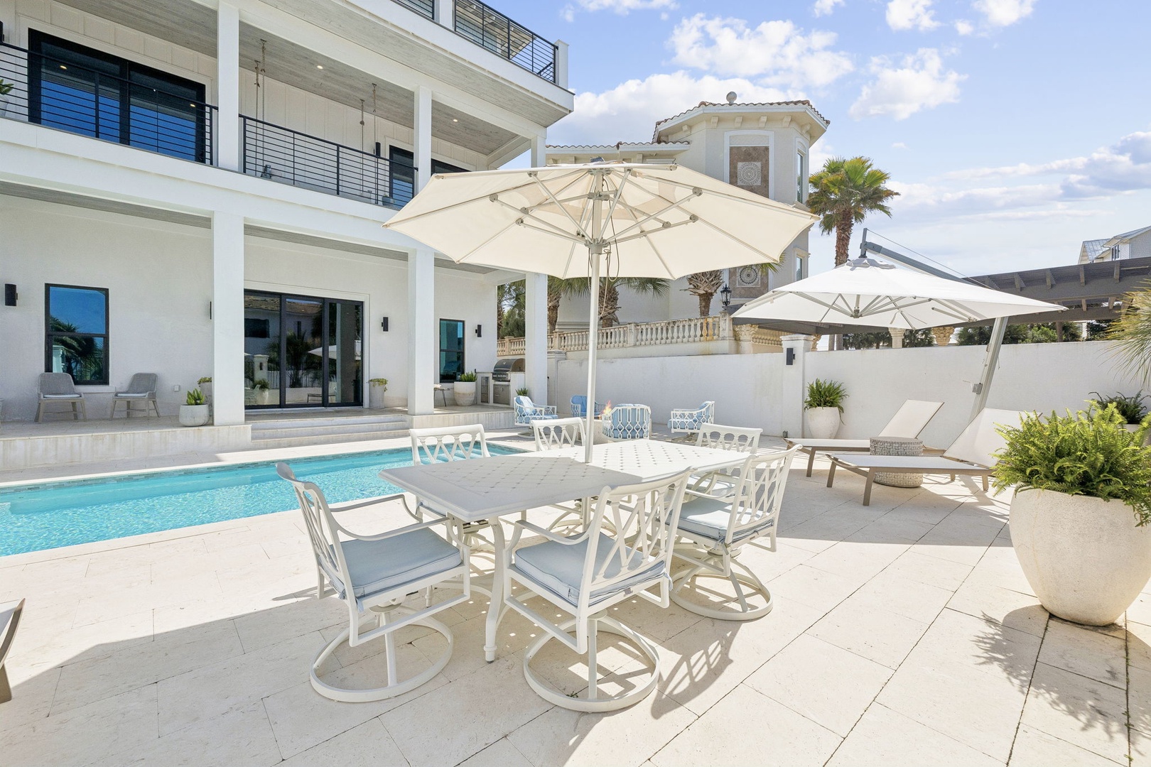 Step onto your private terrace where poolside dining awaits under elegant umbrellas, perfect for memorable meals in the sunshine.