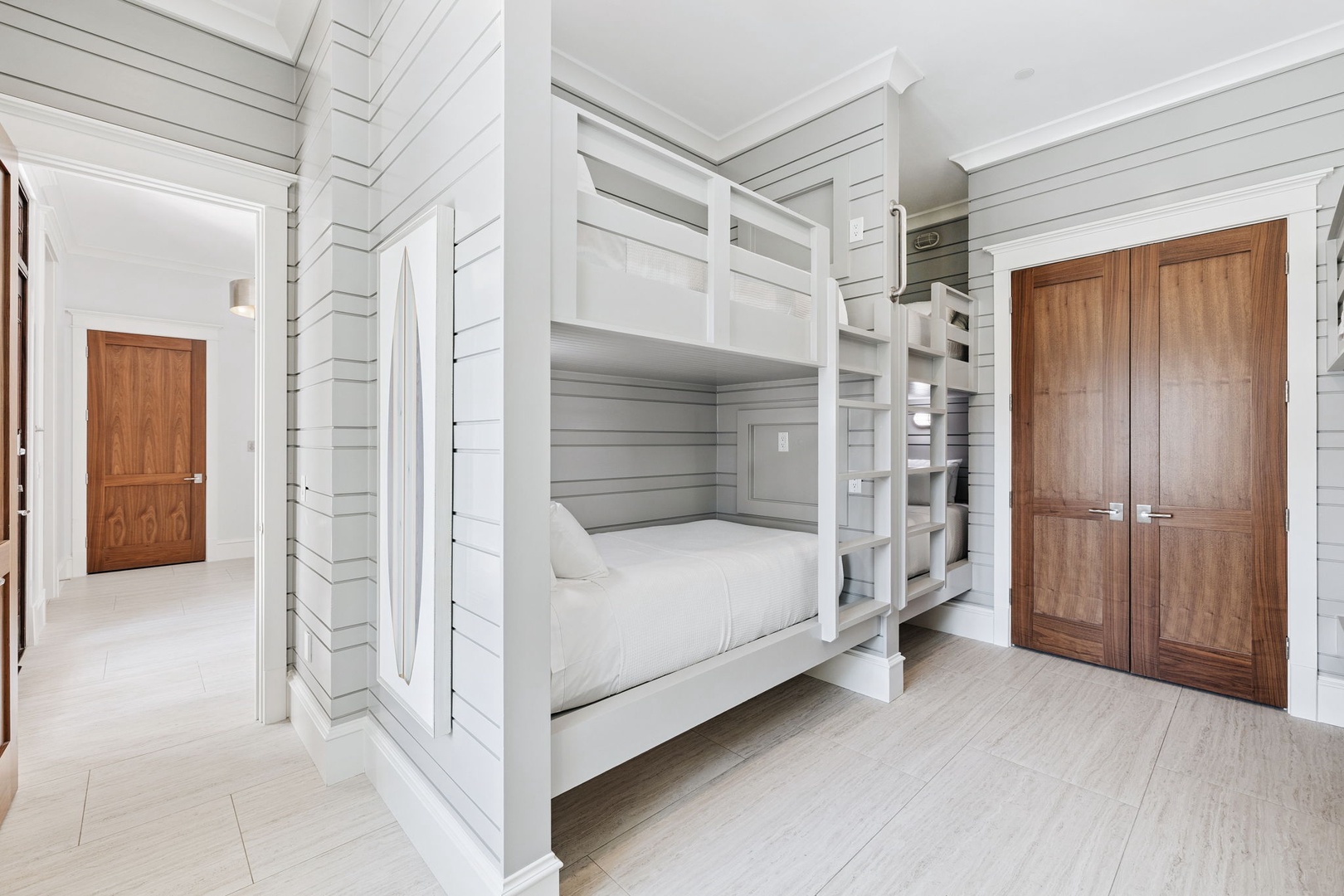 Your cozy bunk room features crisp white linens and plenty of storage space for a comfortable night's rest.