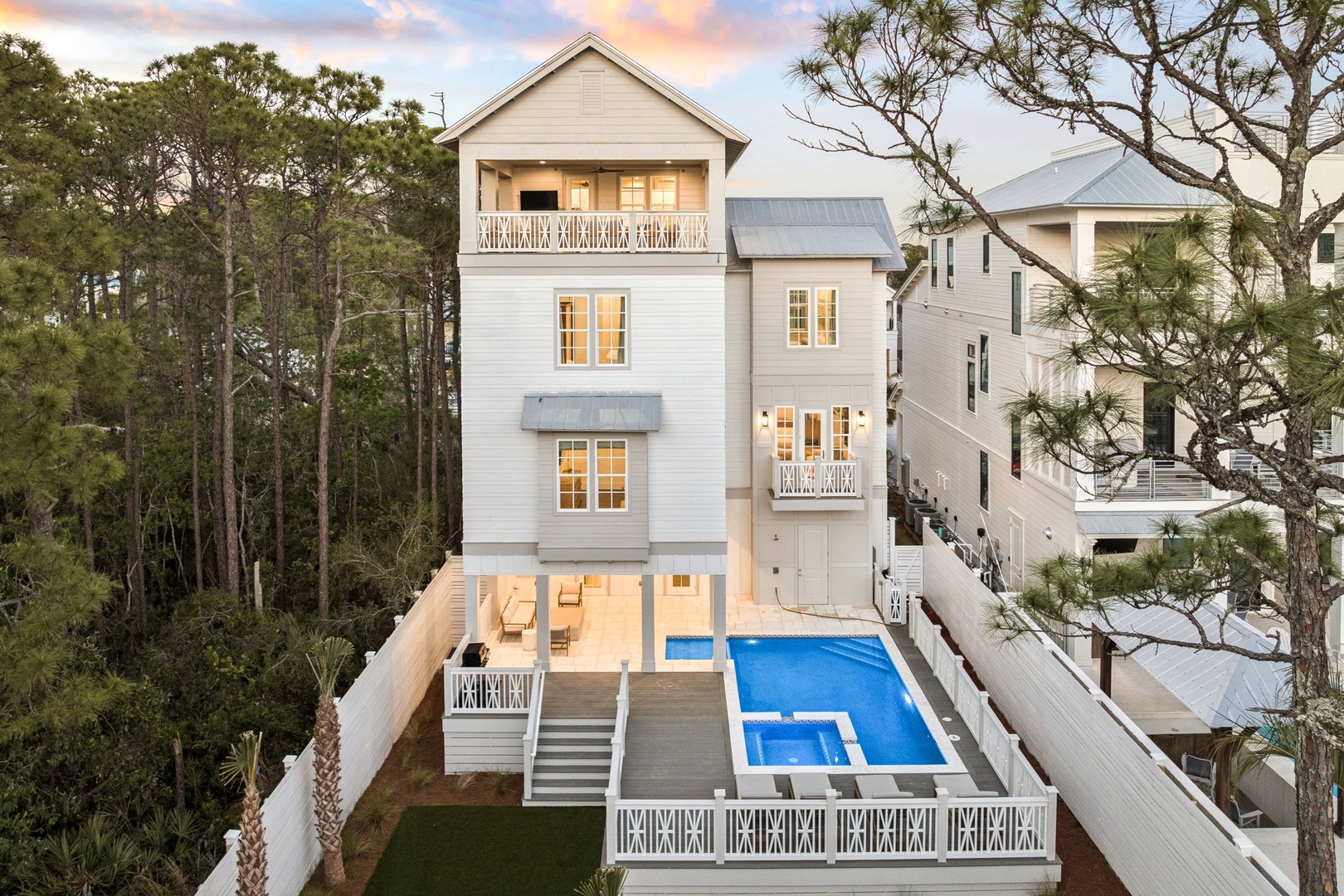 Stunning coastal home with private pool surrounded by towering pines and coastal charm.