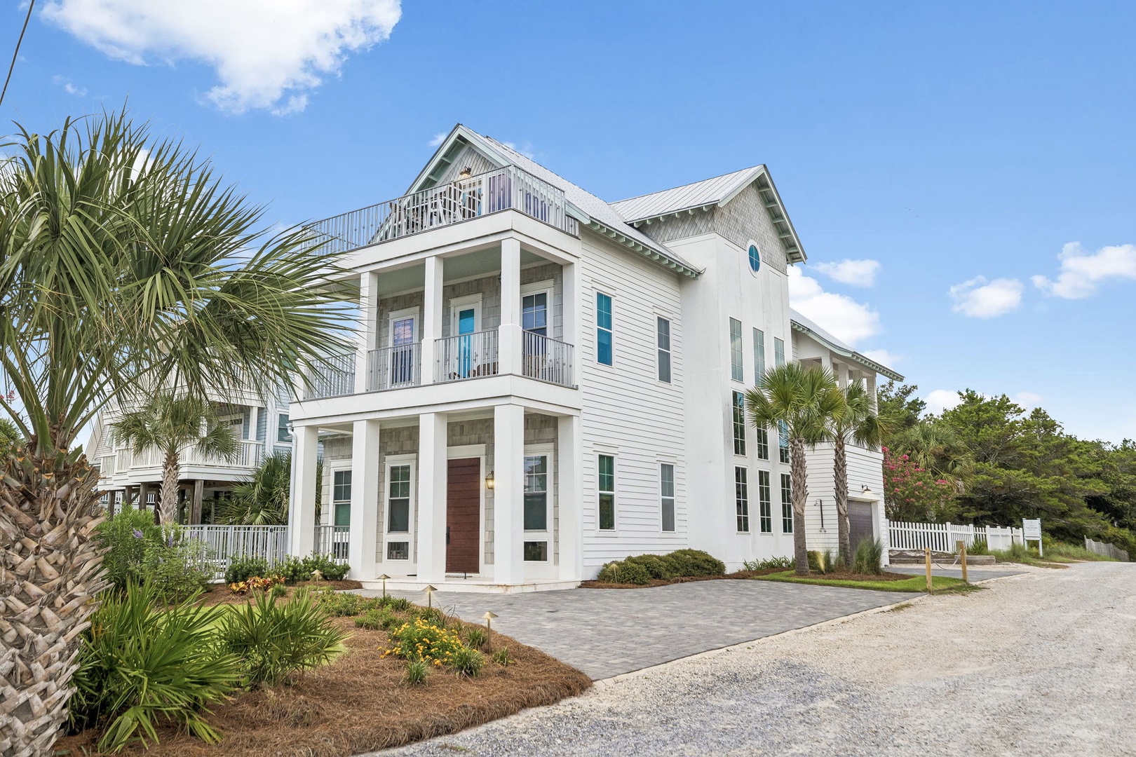 A coastal-style retreat framed by swaying palms and warm sunshine—where your beach getaway begins the moment you arrive.