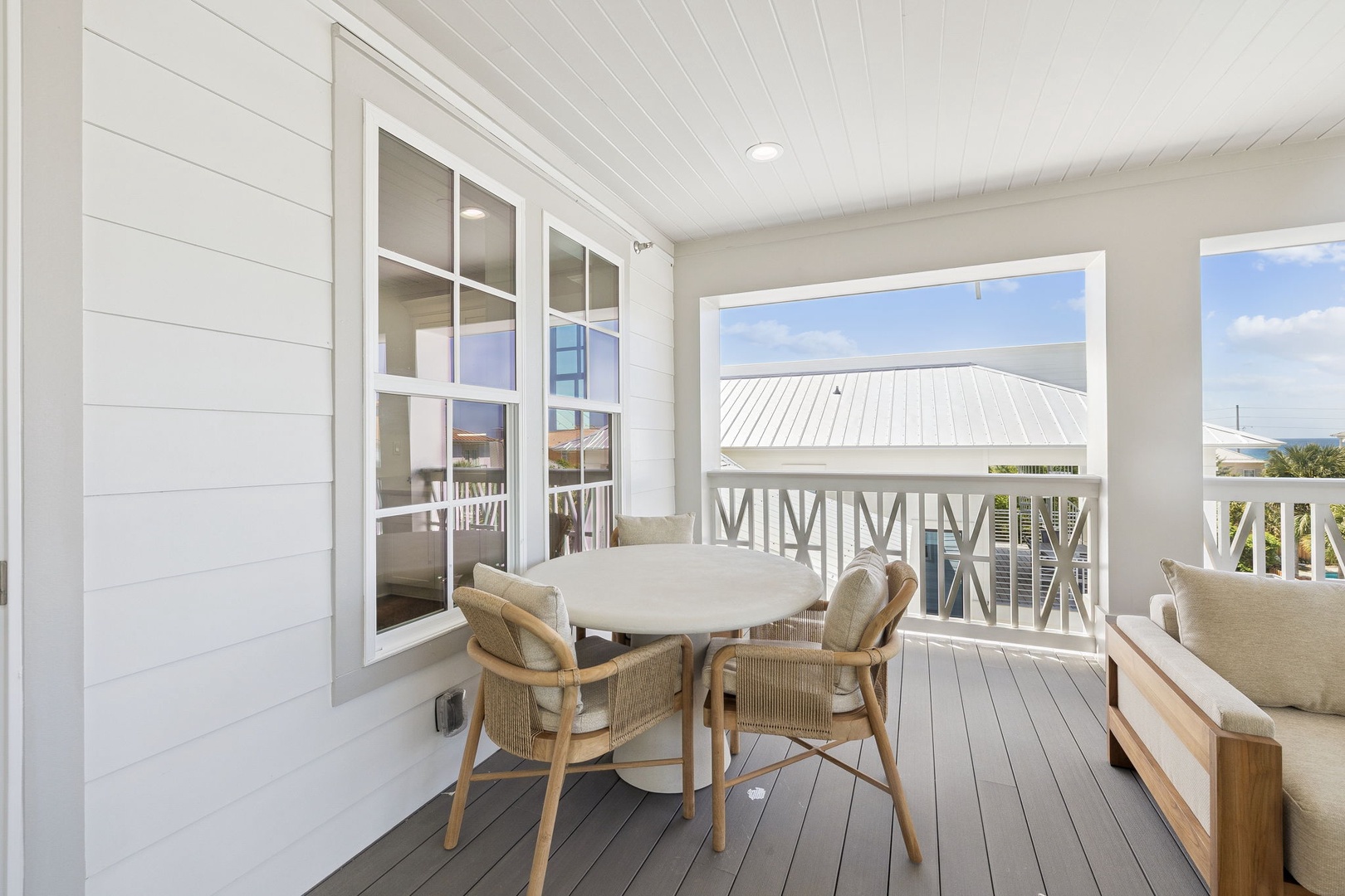 Your private balcony offers coastal charm with comfortable seating where you can enjoy morning coffee or evening meals.