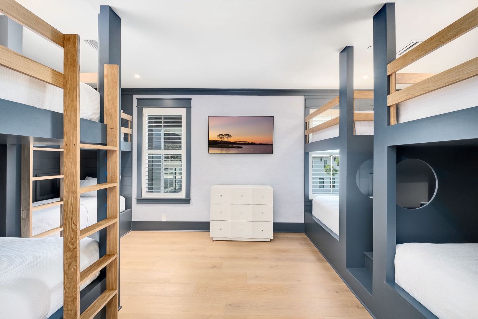 Your group will love this bright bunkroom with custom-built beds, warm wood accents, and plenty of space for everyone to unwind together after a day of adventure.