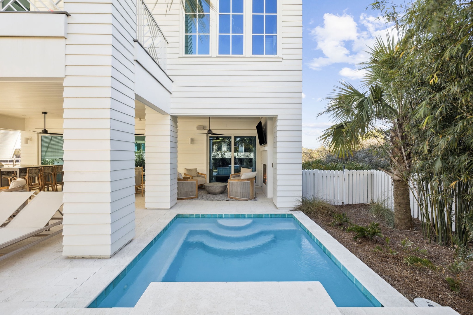 Your private pool awaits beneath swaying palms, with a covered patio perfect for sunset cocktails and peaceful mornings.
