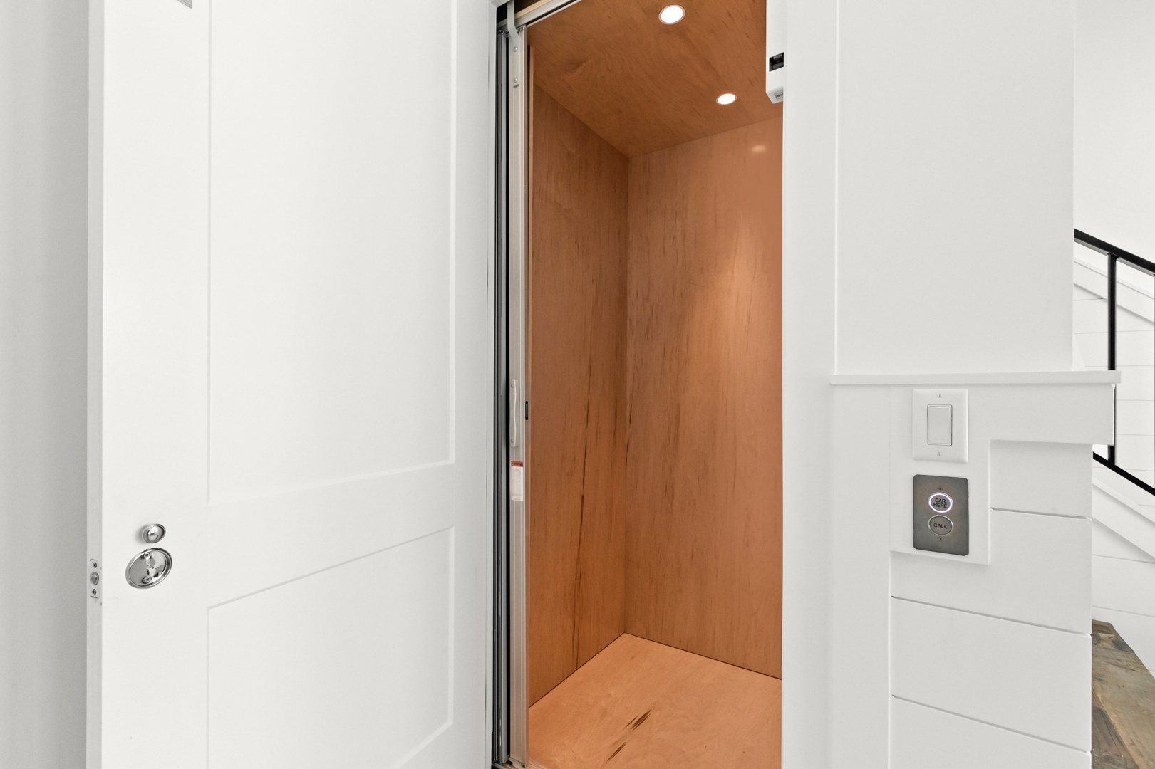 Your convenience is elevated with this private home elevator, offering easy access between floors in a stylish wood-lined cabin.