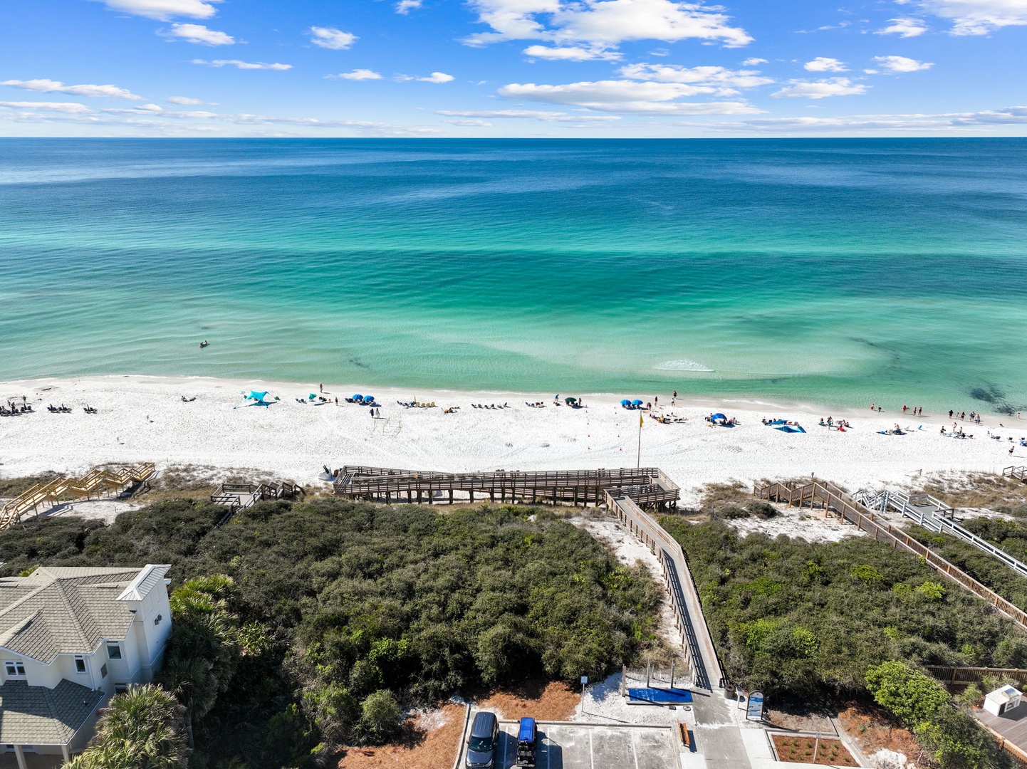 This stunning beachfront location offers direct access to pristine white sand and crystal-clear turquoise waters, with convenient boardwalk paths leading from the property to the shore.