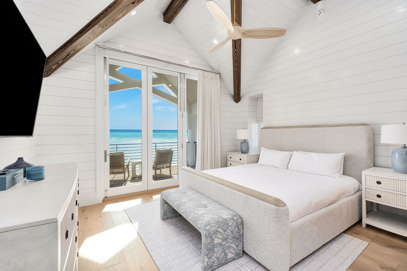 Wake up to ocean waves from your beach-view bedroom where rustic beams meet coastal elegance and ocean breezes drift through.