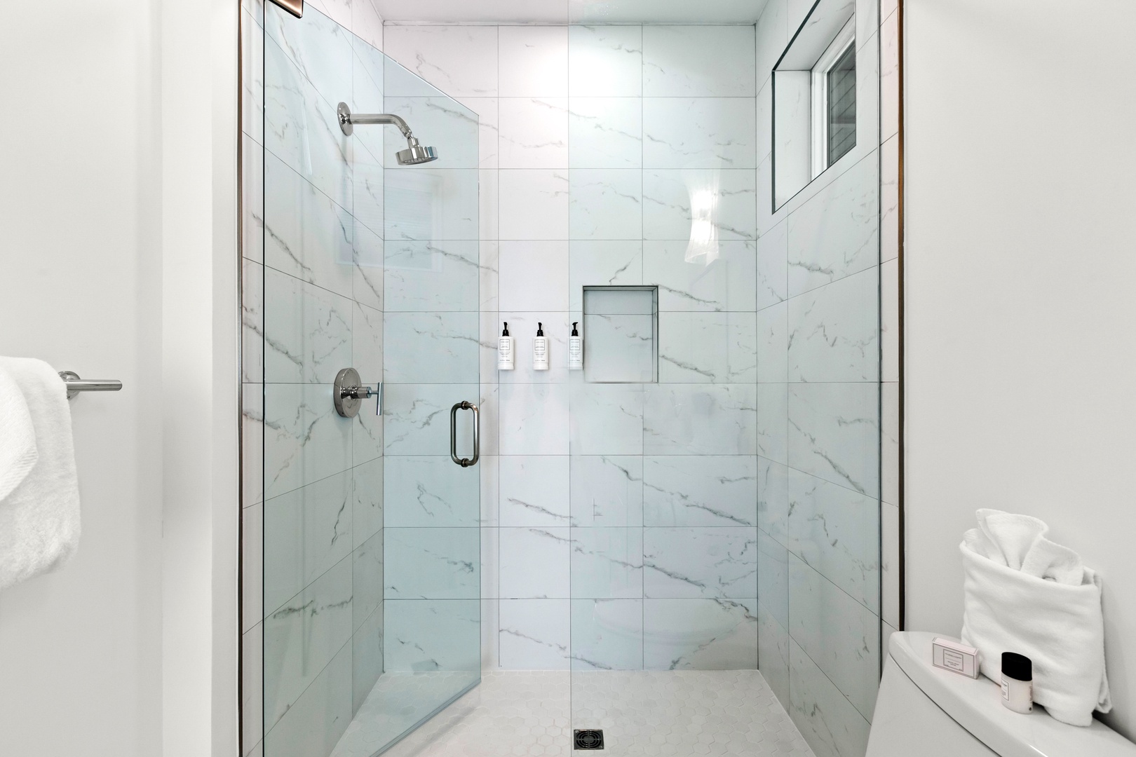 Step into your private marble-tiled shower, where soft rainfall and sleek finishes create a spa-like retreat—perfect for unwinding after your daily adventures.