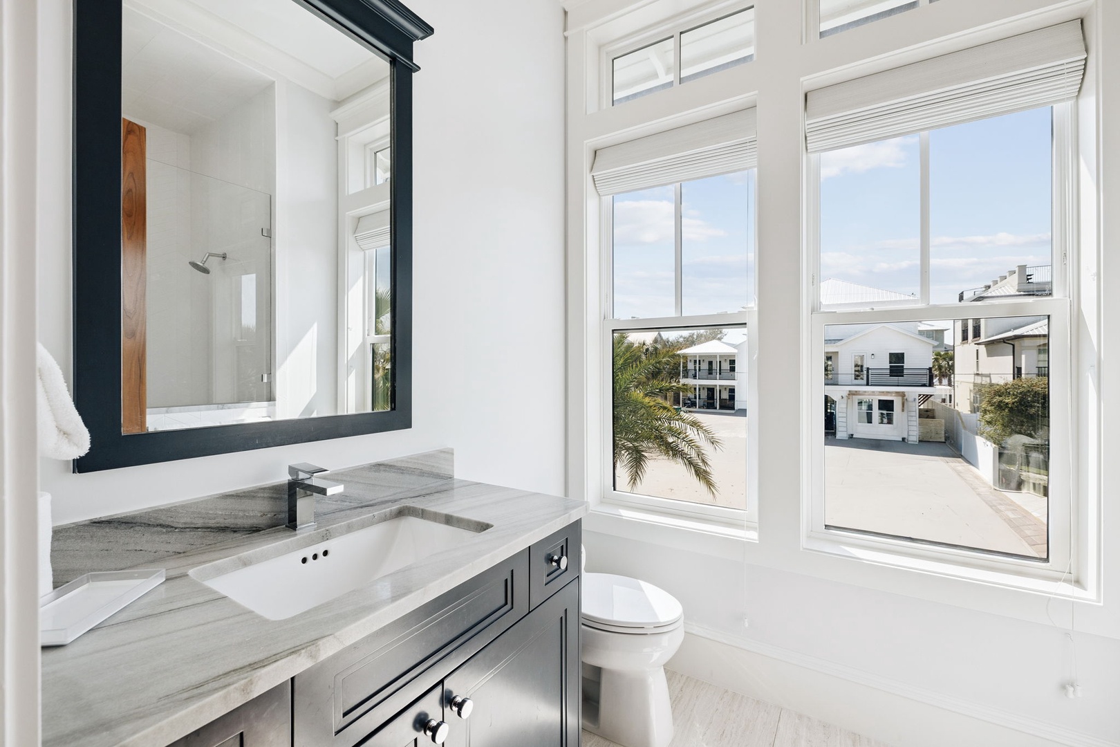 Refresh in your bright, elegant bathroom with stunning city views through oversized windows and premium finishes.
