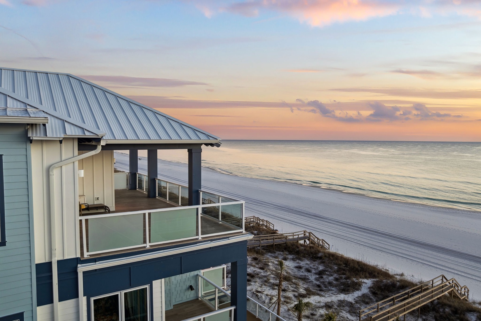 Beachfront property offers stunning sunset views over pristine sandy shores and calm ocean waters.