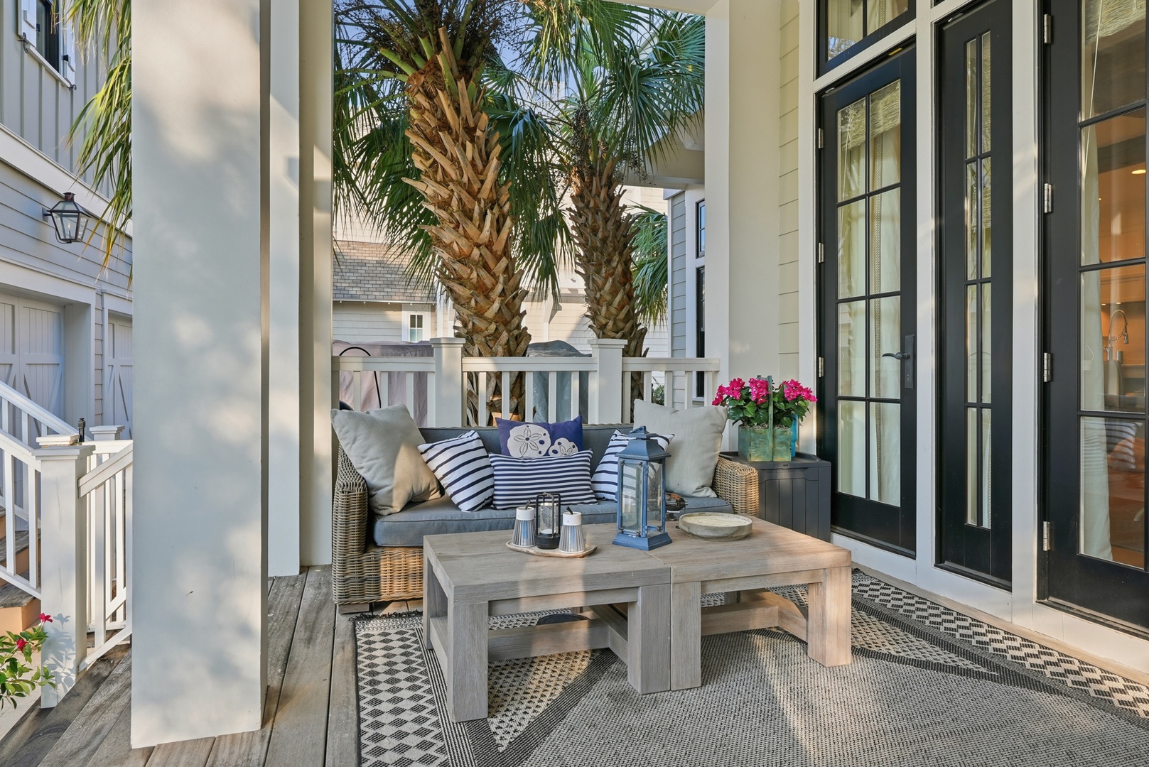 Relax on your private porch surrounded by swaying palms and coastal charm, where comfortable seating invites you to unwind with your morning coffee or evening cocktails.