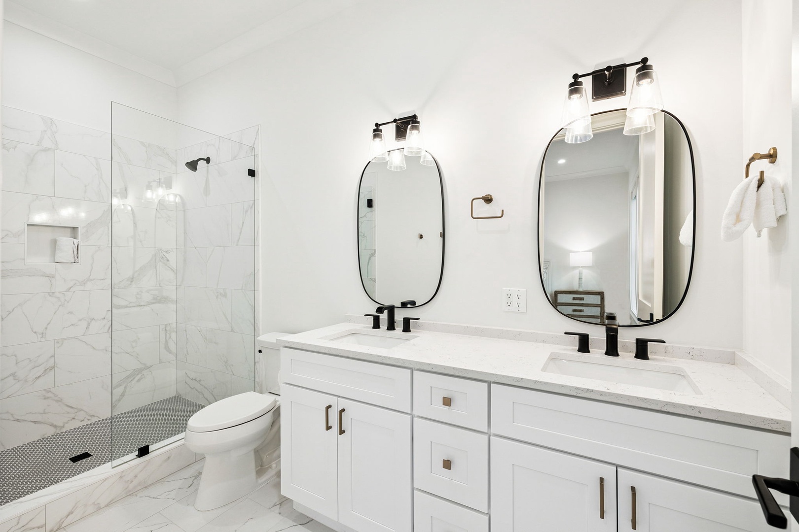 Step into your spa-like bathroom with dual vanities, elegant marble finishes, and a luxurious walk-in shower for ultimate relaxation.