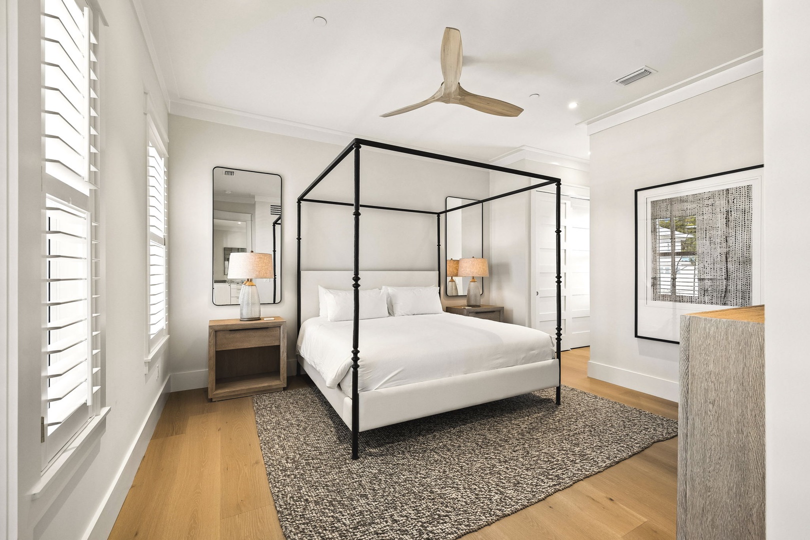 Drift off in this elegant bedroom, where your canopy bed and soft linens promise restful nights under the gentle hum of the ceiling fan.