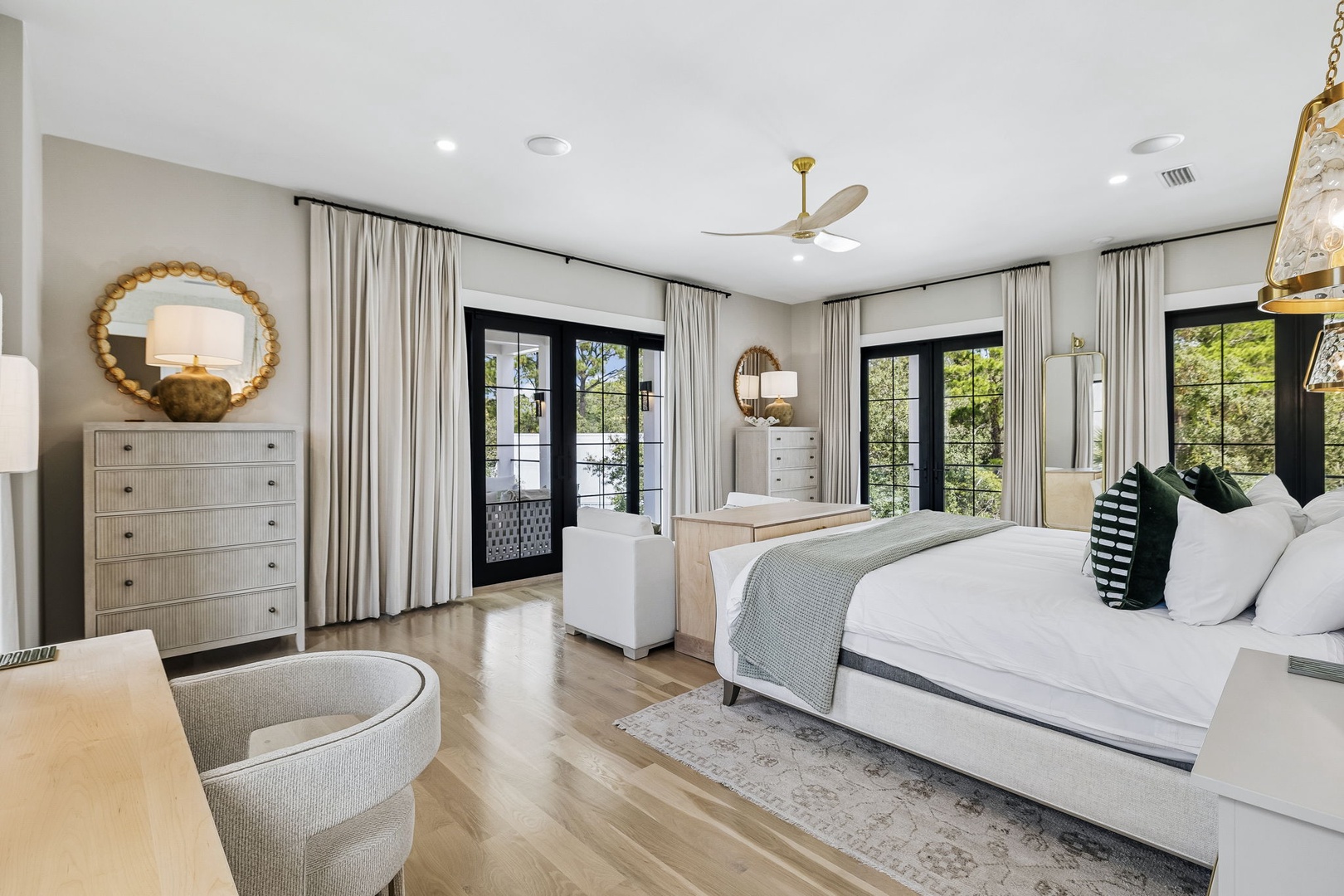 Step into your serene retreat with elegant furnishings, soft natural light, and private balcony access surrounded by lush greenery.