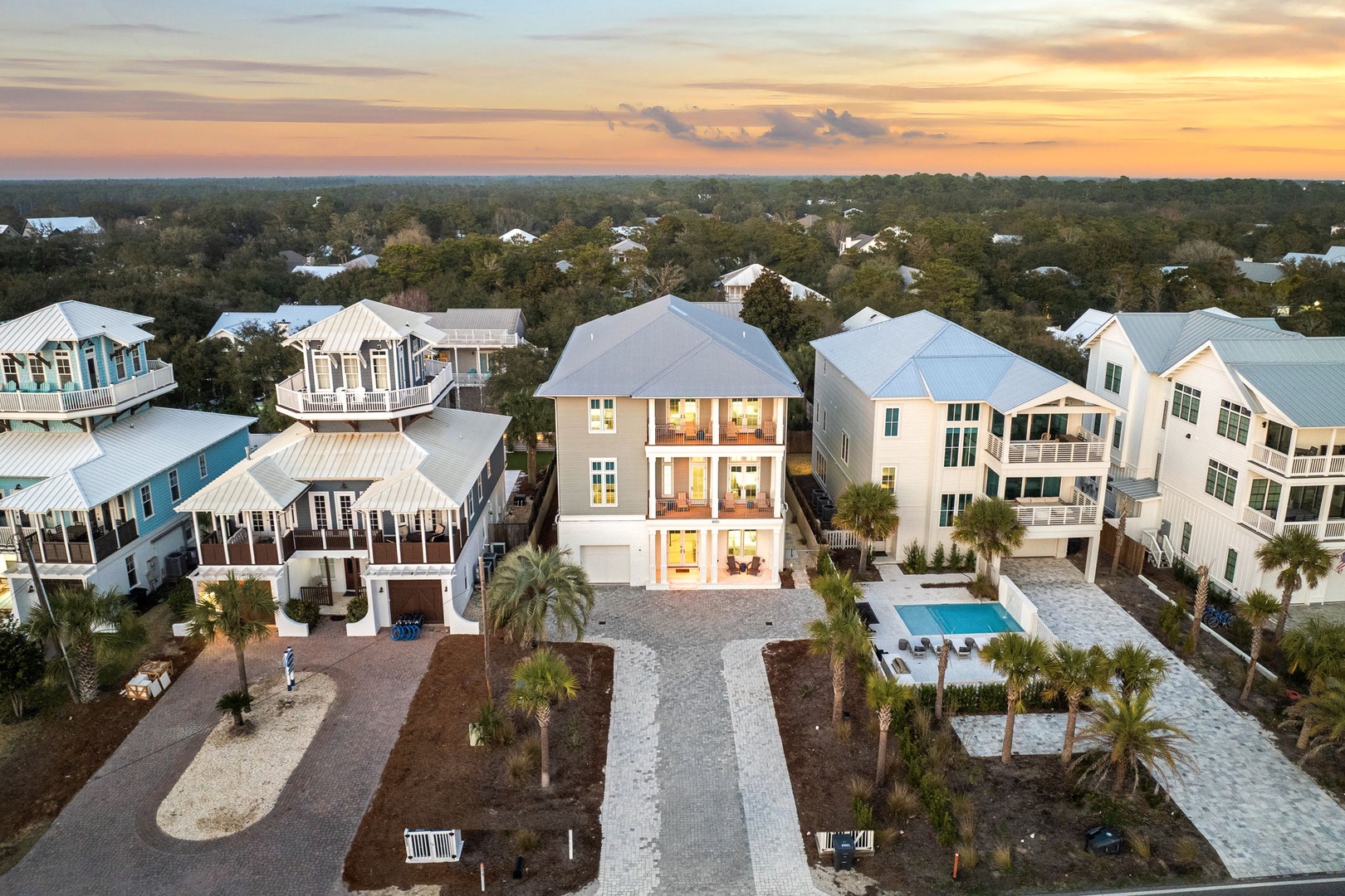Stunning aerial view of beachside vacation homes nestled in a peaceful residential community at golden hour.