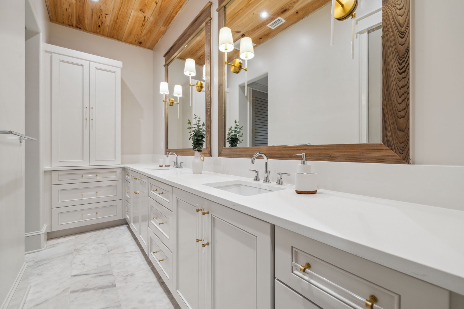 Refresh in your private spa-like bathroom featuring dual vanities, warm wood accents, and elegant fixtures—your perfect start to each vacation morning.