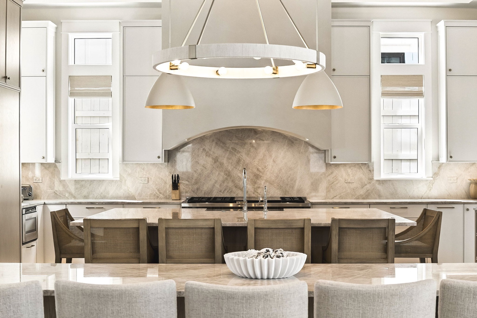 Step into your gourmet kitchen, where elegant marble backsplash and custom cabinetry create the perfect space for preparing memorable meals together.