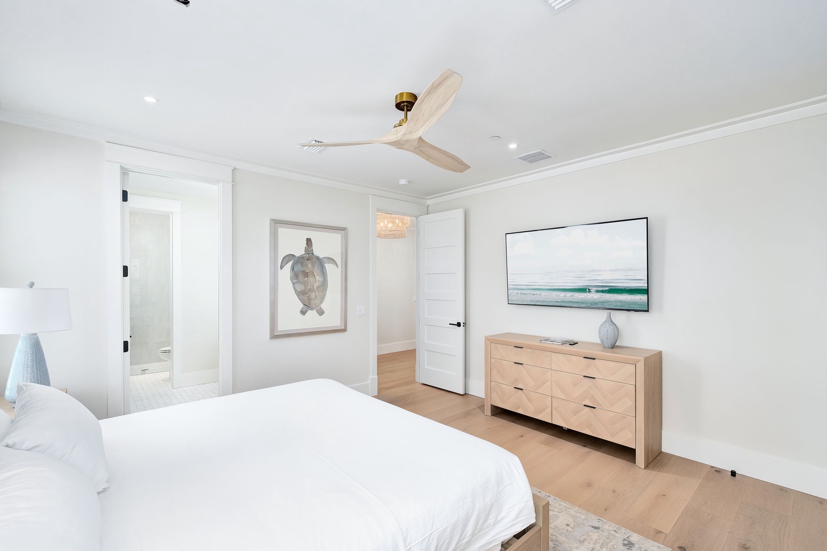 Your serene coastal retreat awaits with crisp white linens, calming ocean-inspired artwork, and natural wood accents that create a peaceful sanctuary for restful nights.