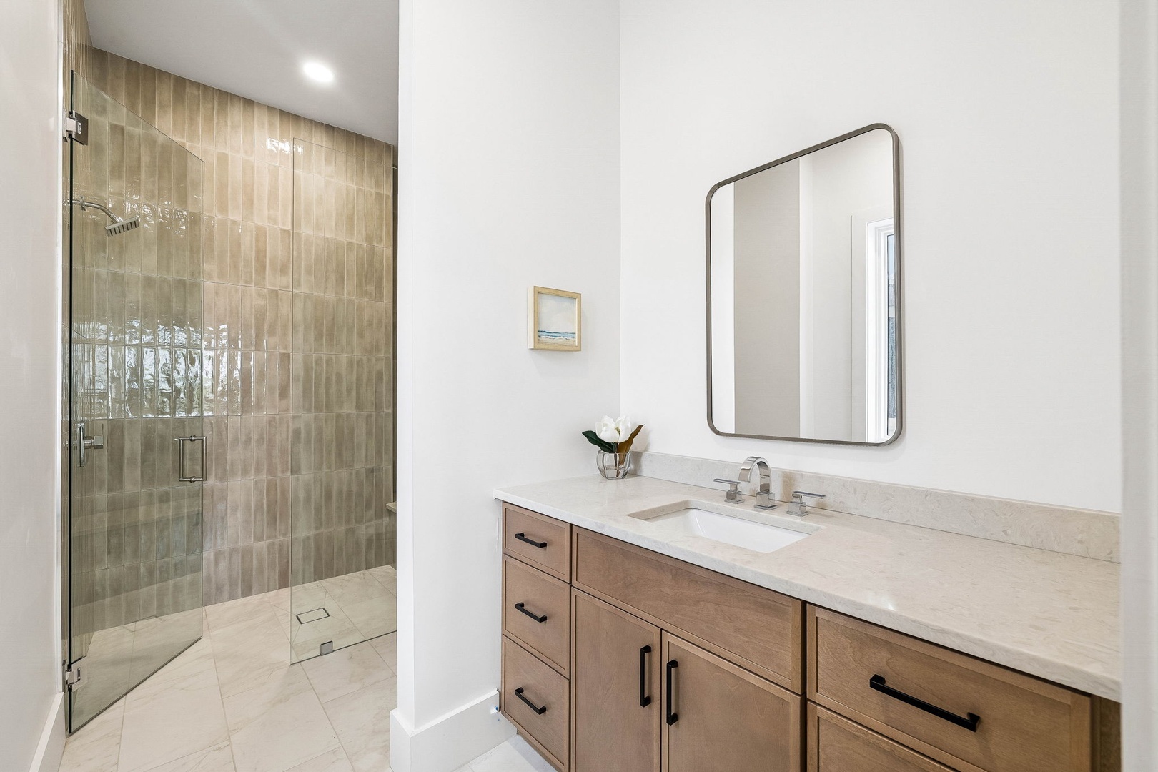 Step into your beautifully appointed bathroom featuring a spacious walk-in shower and elegant vanity space designed for your comfort and relaxation.