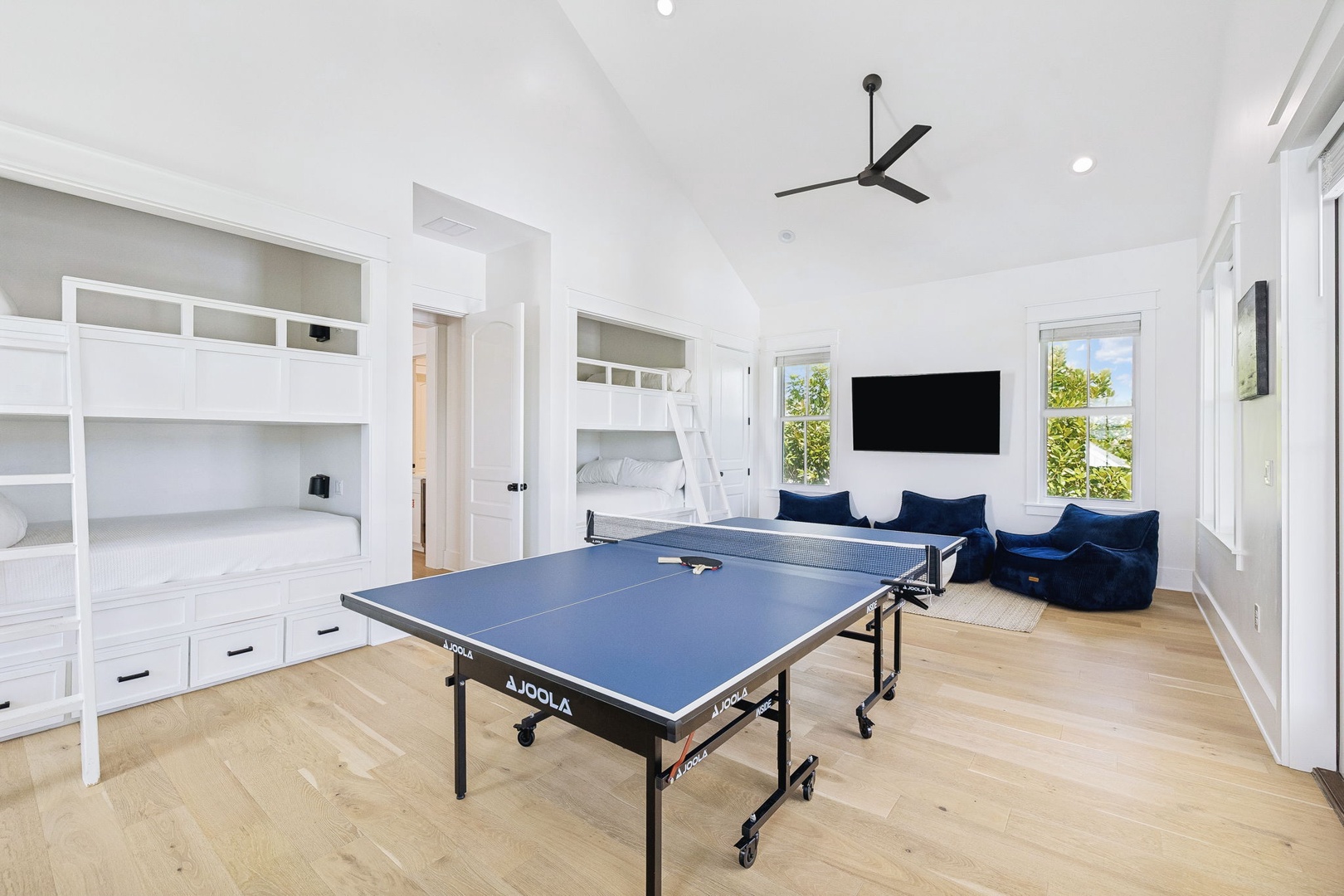 Challenge your group to a ping pong match in this bright, fun-filled game room with built-in bunk beds and cozy lounge seating for downtime.