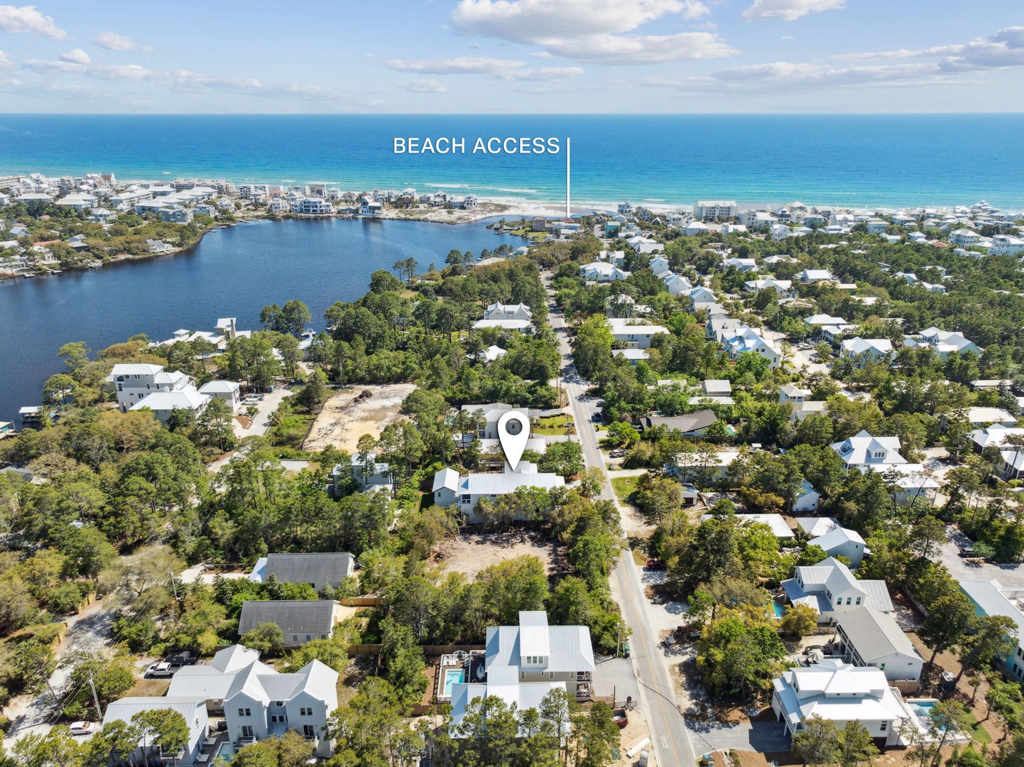 Coastal community with easy beach access via residential streets through established neighborhood with mature trees and nearby water features.