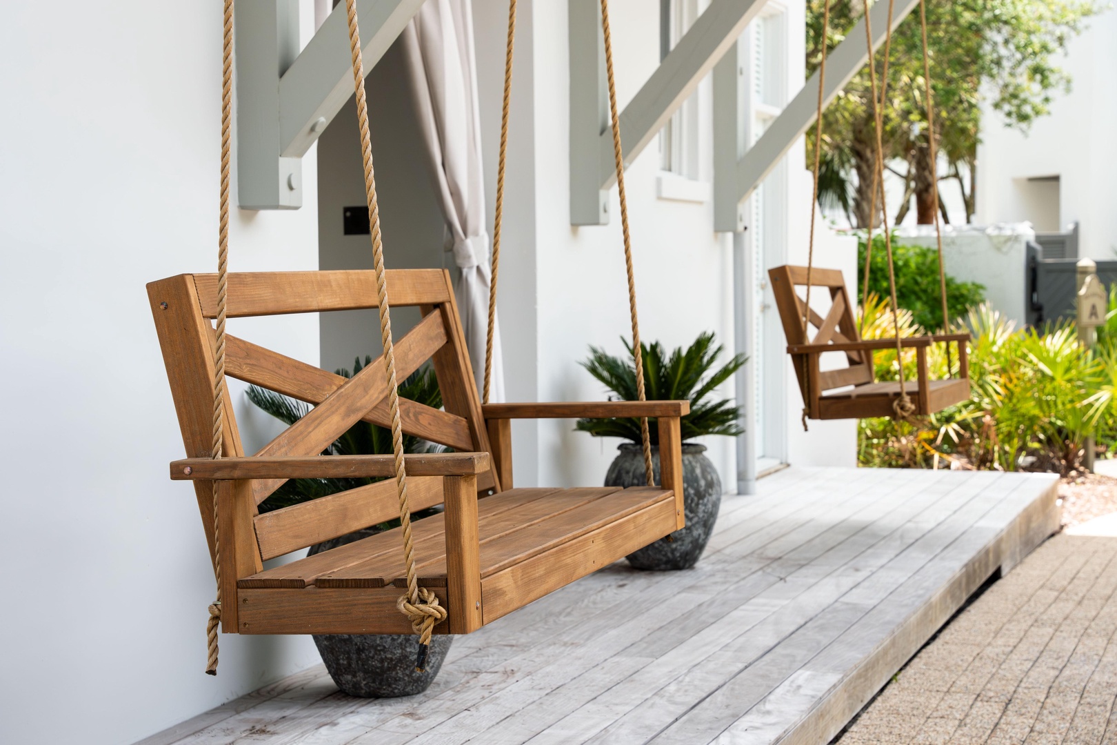 Picture yourself gently swaying on your private wooden swing, sipping morning coffee as tropical breezes flow through your peaceful porch sanctuary.