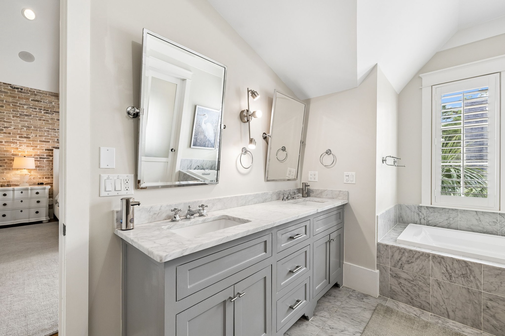 Step into your beautifully designed bathroom with elegant marble countertops, a double vanity, and a luxurious soaking tub that invites you to unwind after a day of exploring.