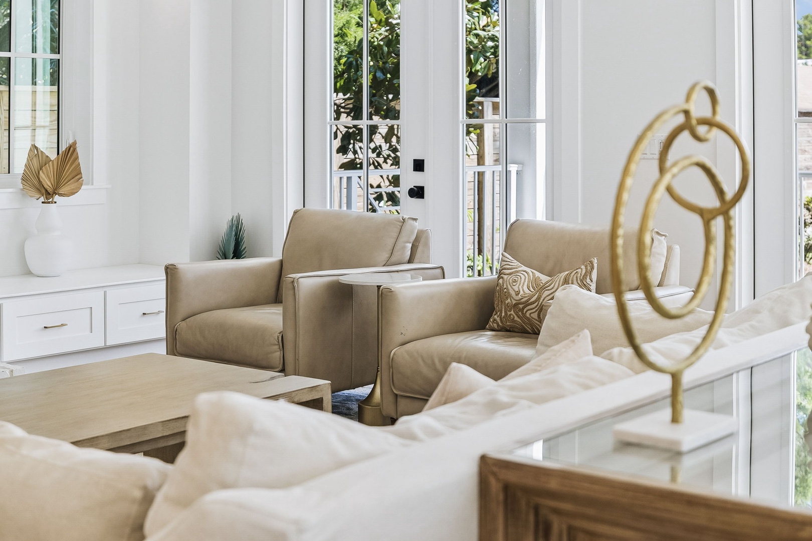 Sink into elegant comfort in this bright living space, where plush seating and gold accents create your perfect retreat for unwinding after a day of adventure.