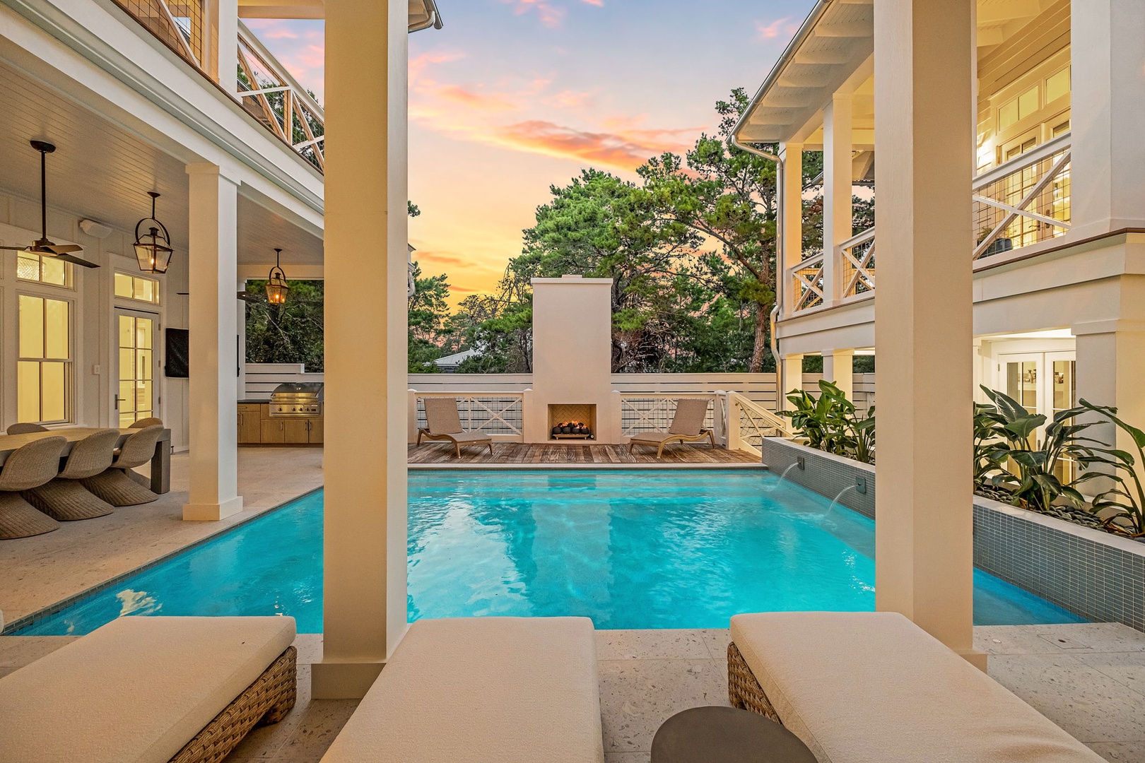 Sink into your sunbed poolside as the sky glows pink and gold at dusk, with your private outdoor fireplace and kitchen ready to extend the evening.