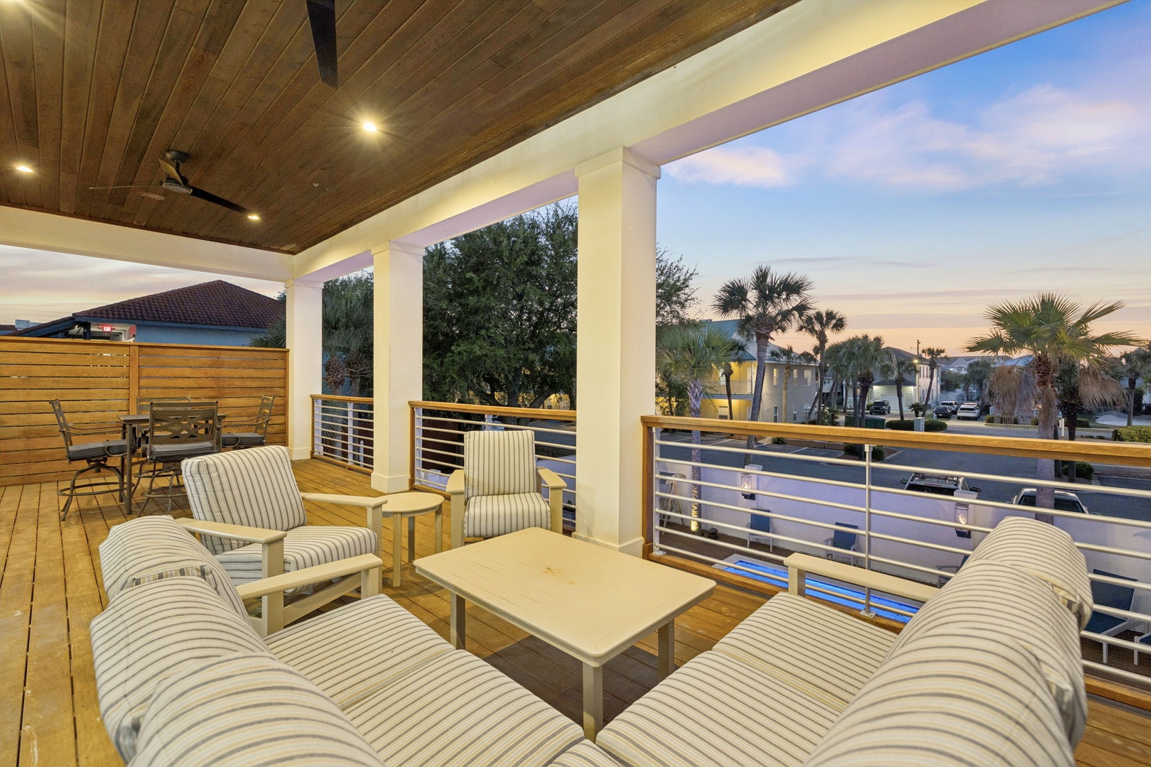 Unwind on your private covered terrace with comfortable seating and beautiful sunset views over the tropical neighborhood.