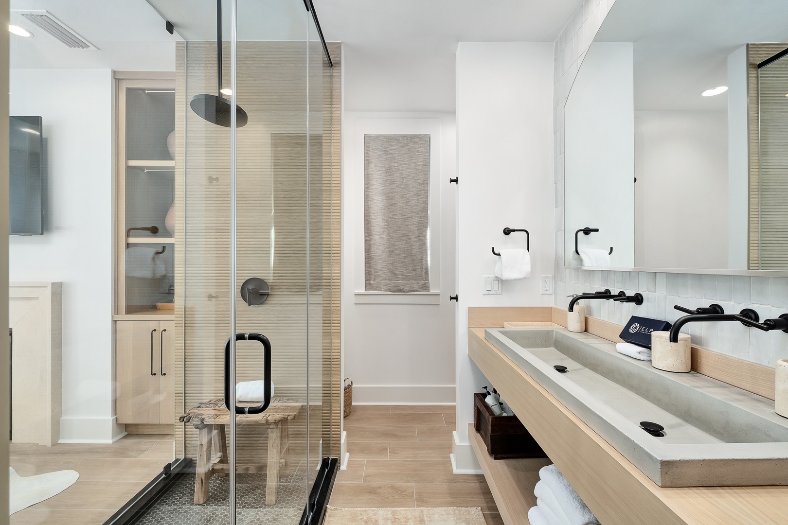Your spa-like bathroom features a spacious glass shower, dual vanity with modern fixtures, and thoughtfully curated amenities for ultimate relaxation.