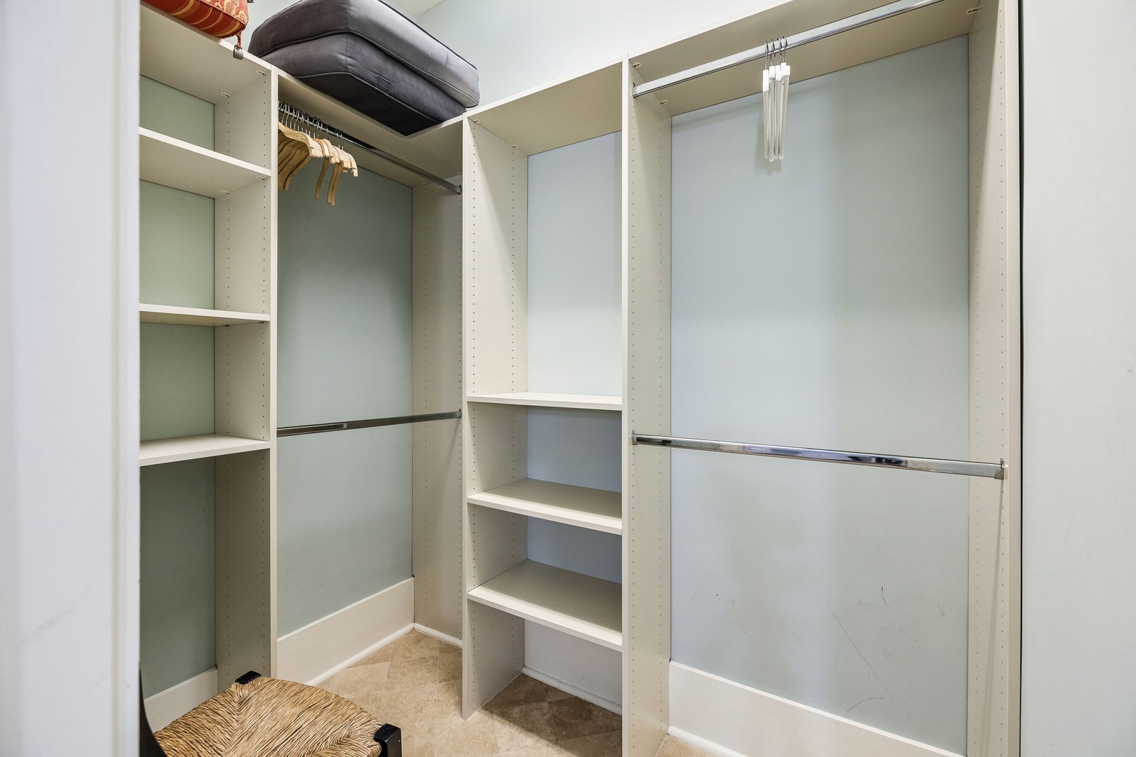 Generous closet space with hanging rods and shelving gives you plenty of room to settle in and feel at home during your stay.