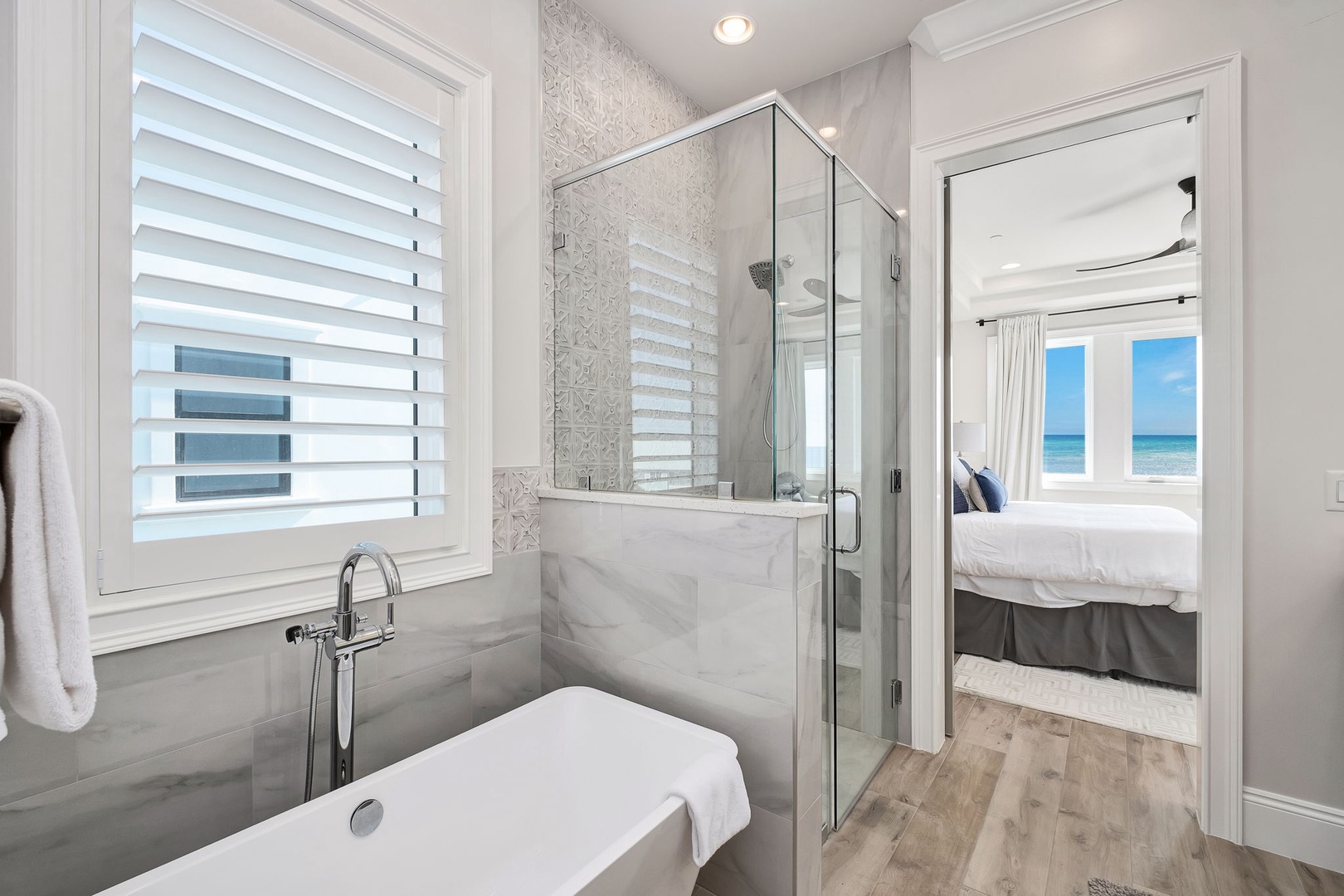Unwind in your marble sanctuary with soaking tub and walk-in shower, steps from your ocean-view bedroom.