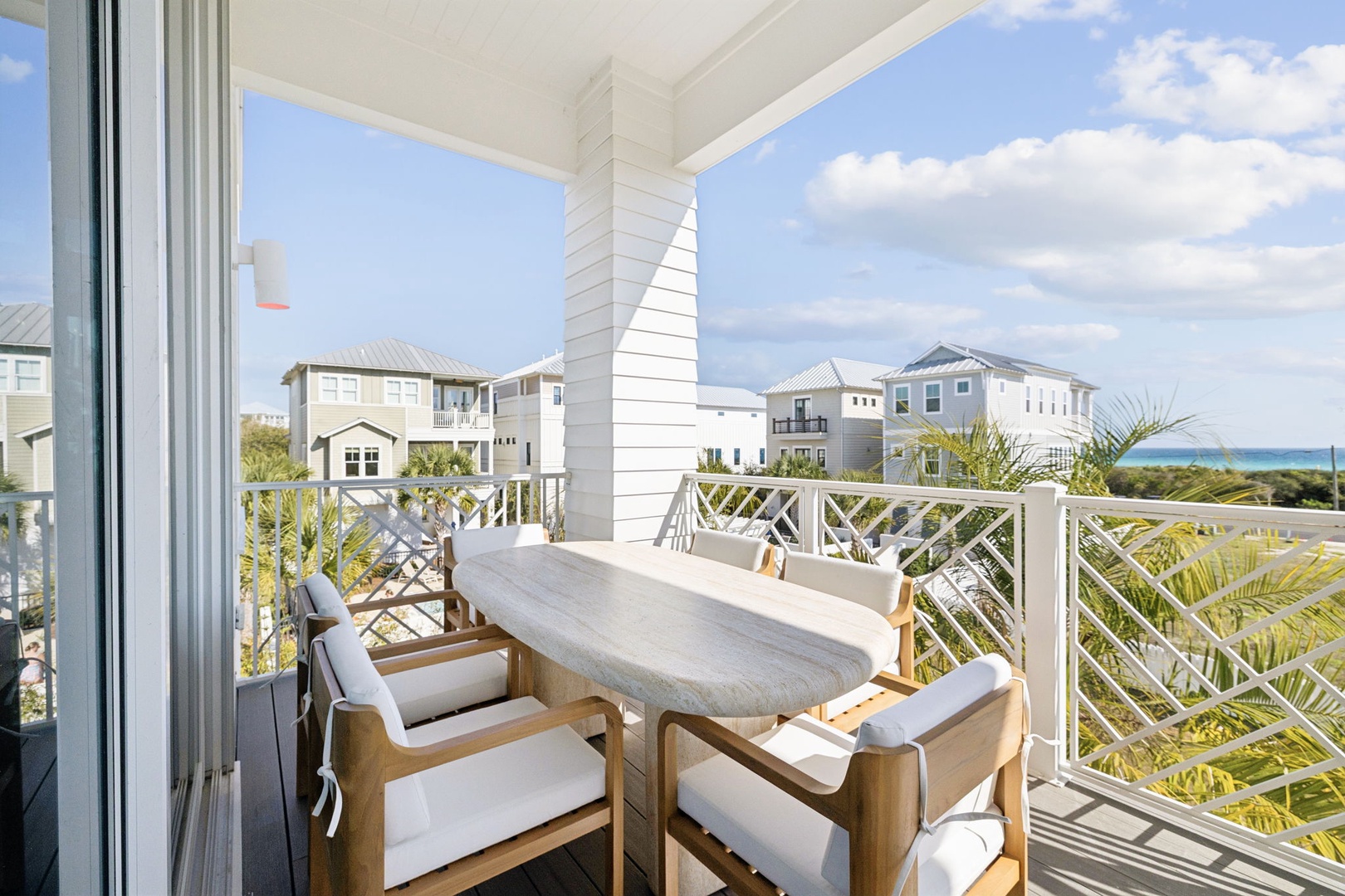 Step onto your private balcony where morning coffee becomes a ritual with ocean glimpses and coastal charm surrounding you.