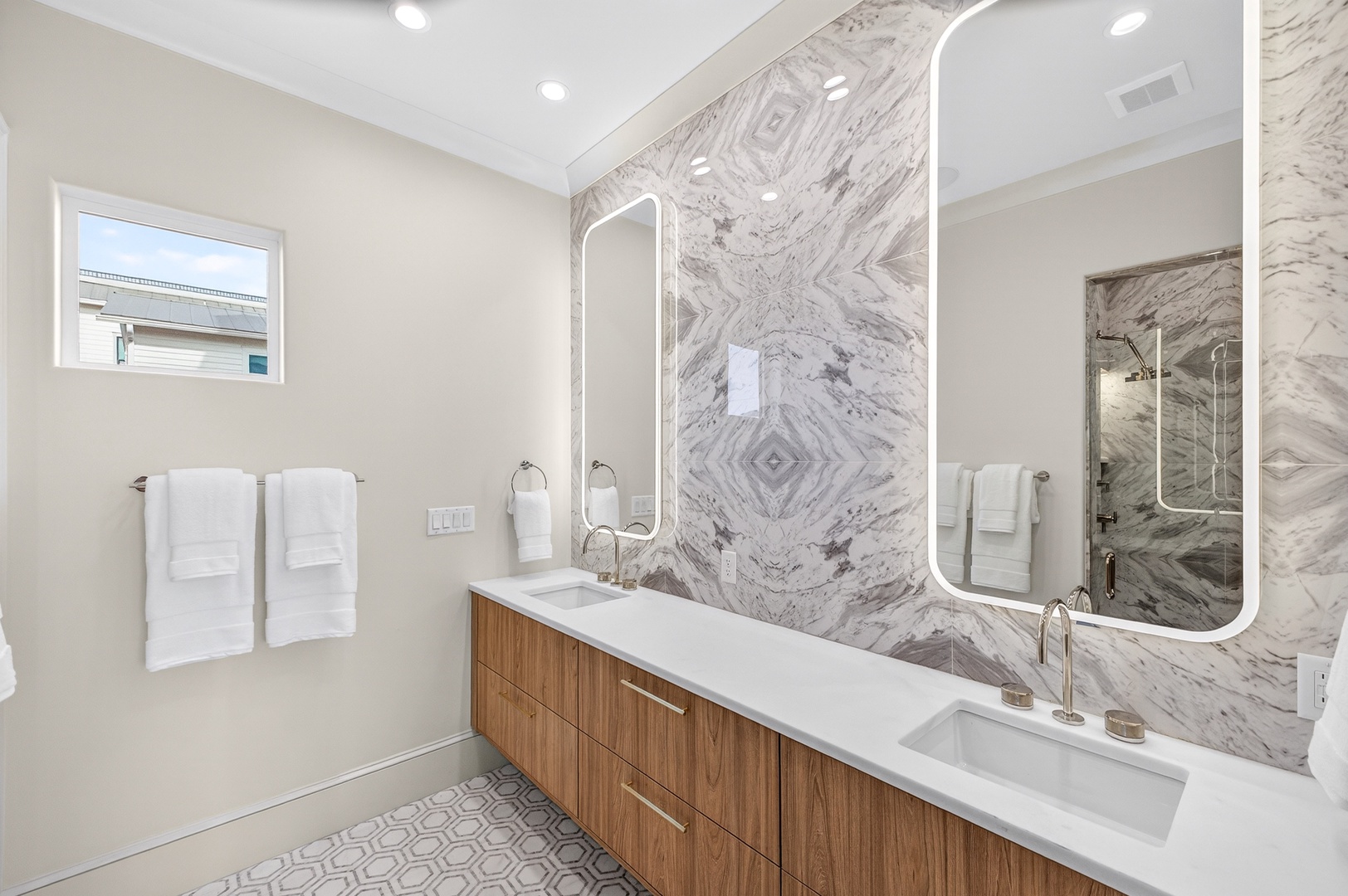 Step into your spa-like sanctuary with stunning marble accent walls, double vanity, and luxury finishes for your morning ritual.