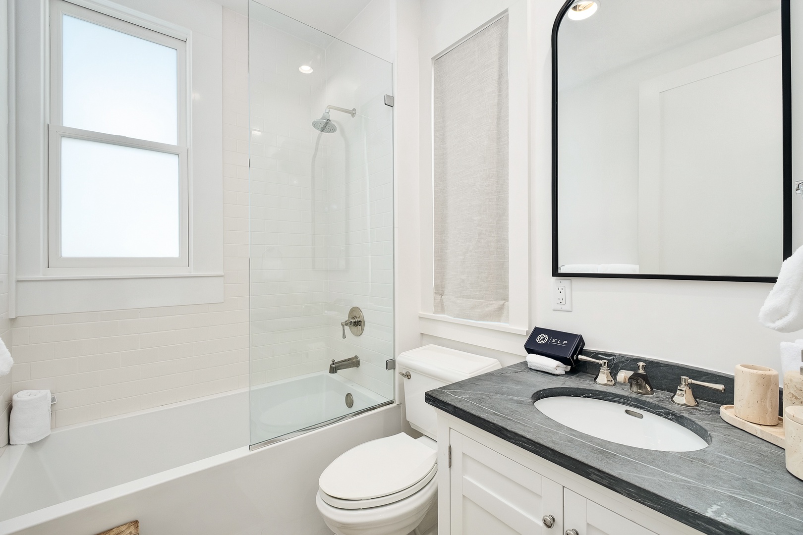 Step into your pristine bathroom featuring a marble vanity, soaking tub, and glass shower for luxurious daily rituals.