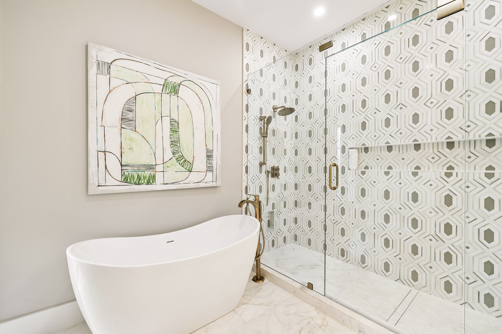 Sink into the freestanding tub or refresh in your spacious walk-in shower, framed by elegant geometric tile that brings a touch of modern artistry to your private spa-like retreat.