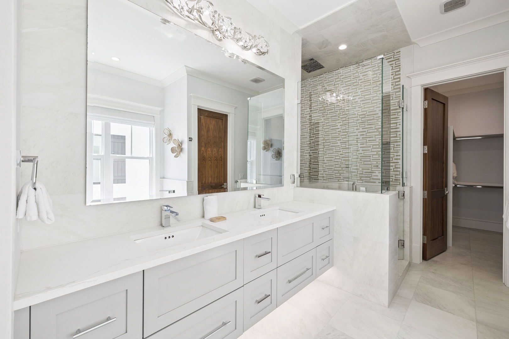Unwind in your spa-like ensuite with dual vanities, rainfall shower, and elegant marble finishes.