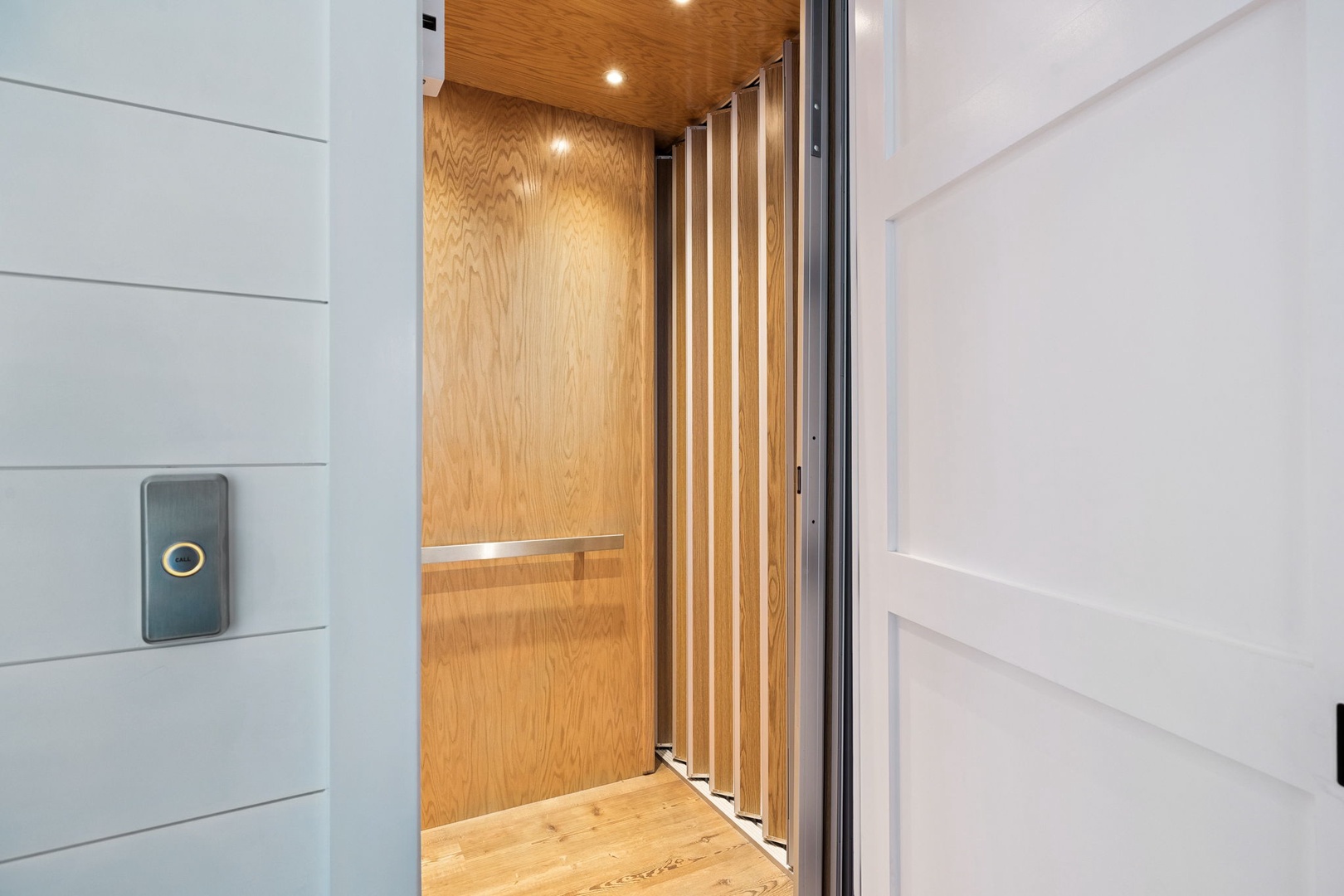 Step into your modern elevator with warm wood interiors and sleek lighting for effortless access between floors.